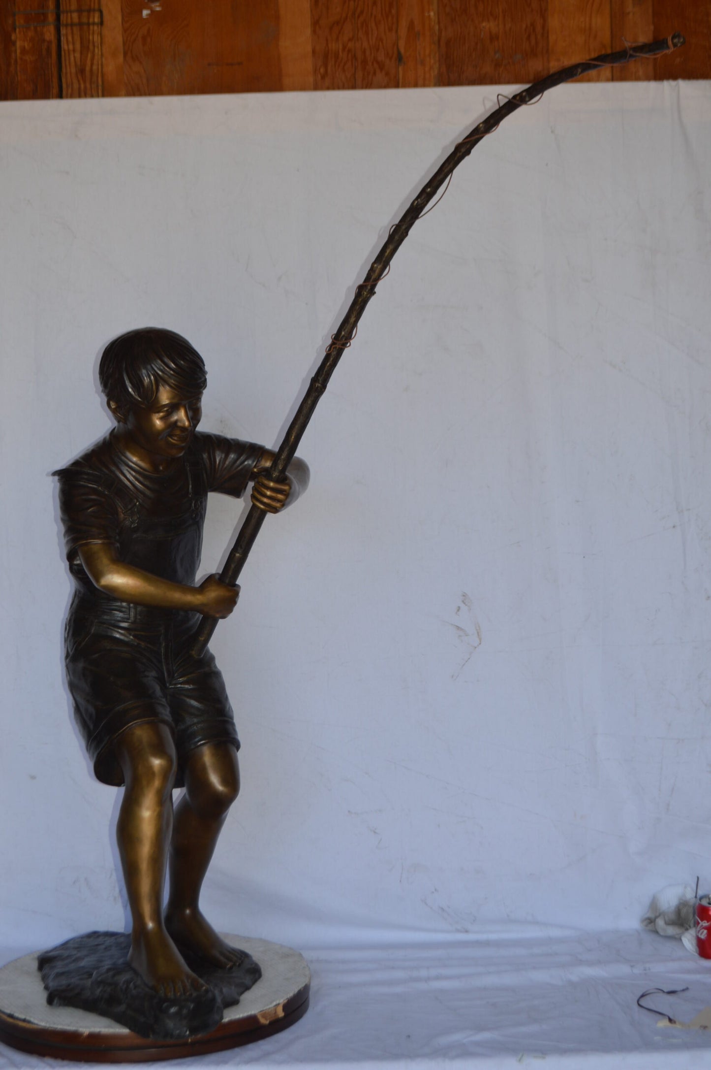 A Young Boy Fishing Bronze Statue - Size: 16"L x 54"W x 62"H.