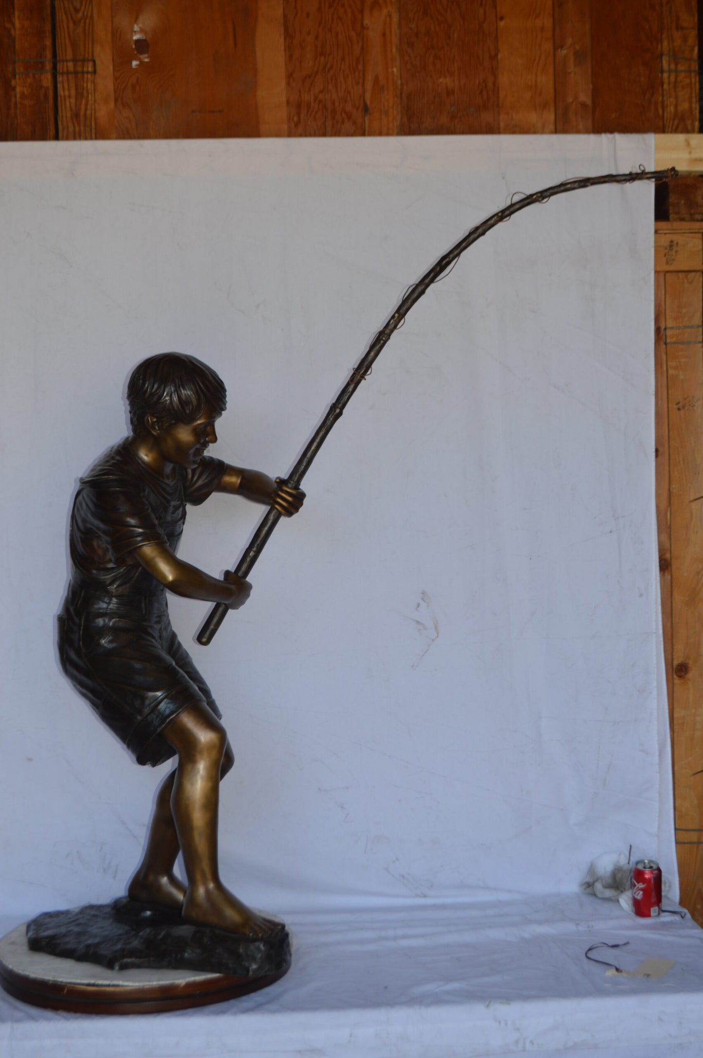 A Young Boy Fishing Bronze Statue - Size: 16"L x 54"W x 62"H.
