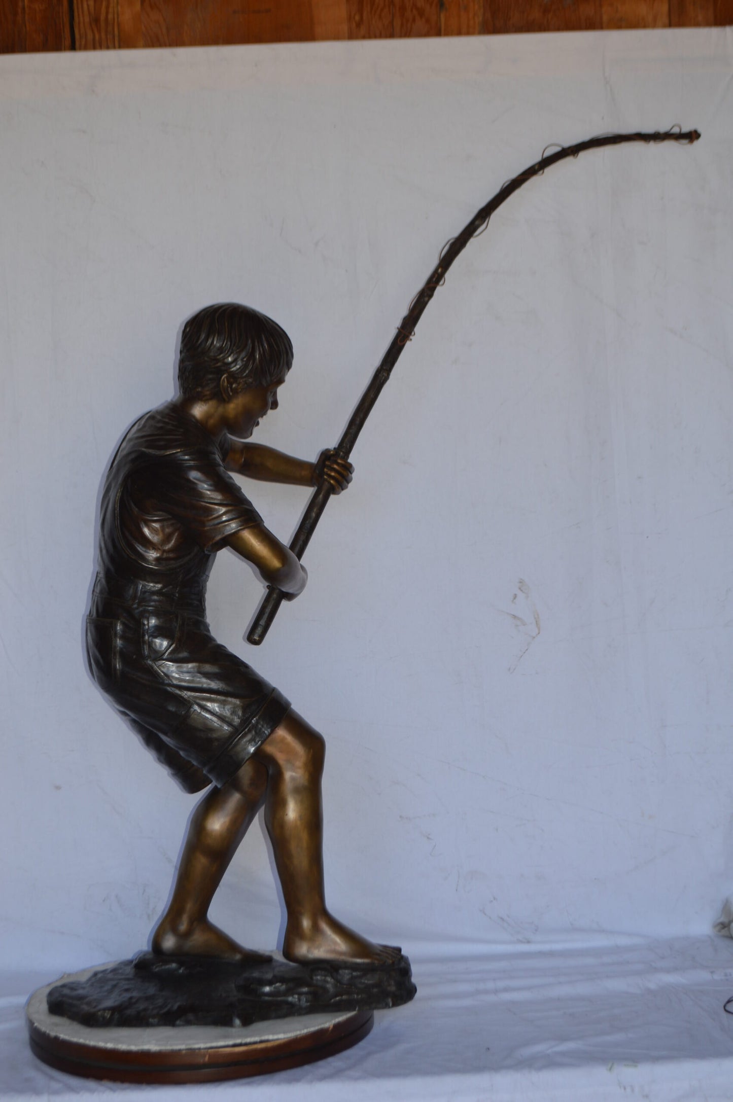 A Young Boy Fishing Bronze Statue - Size: 16"L x 54"W x 62"H.