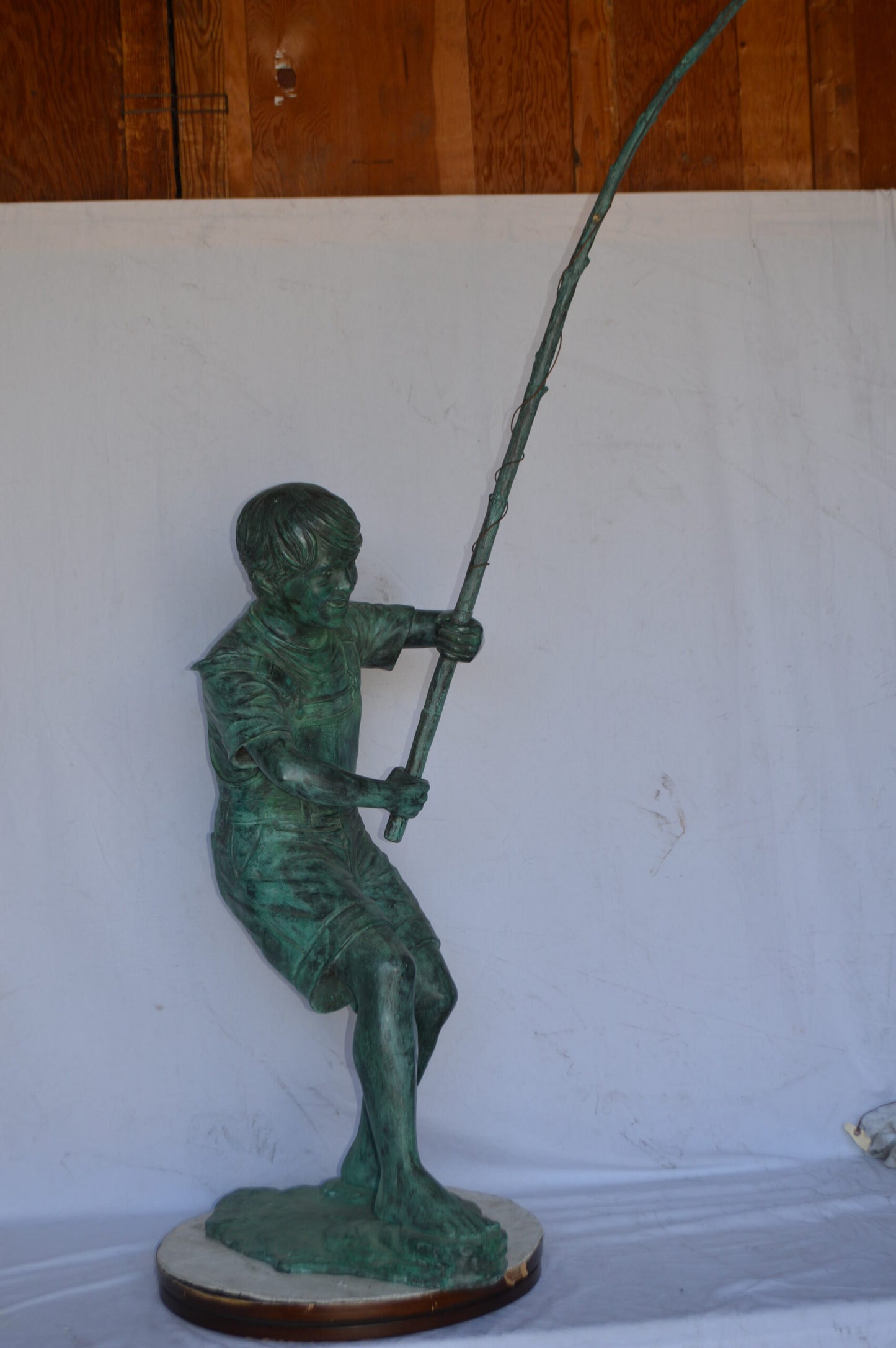 Young Boy Fishing Bronze Statue - green patina - Size: 16"L x 54"W x 62"H.
