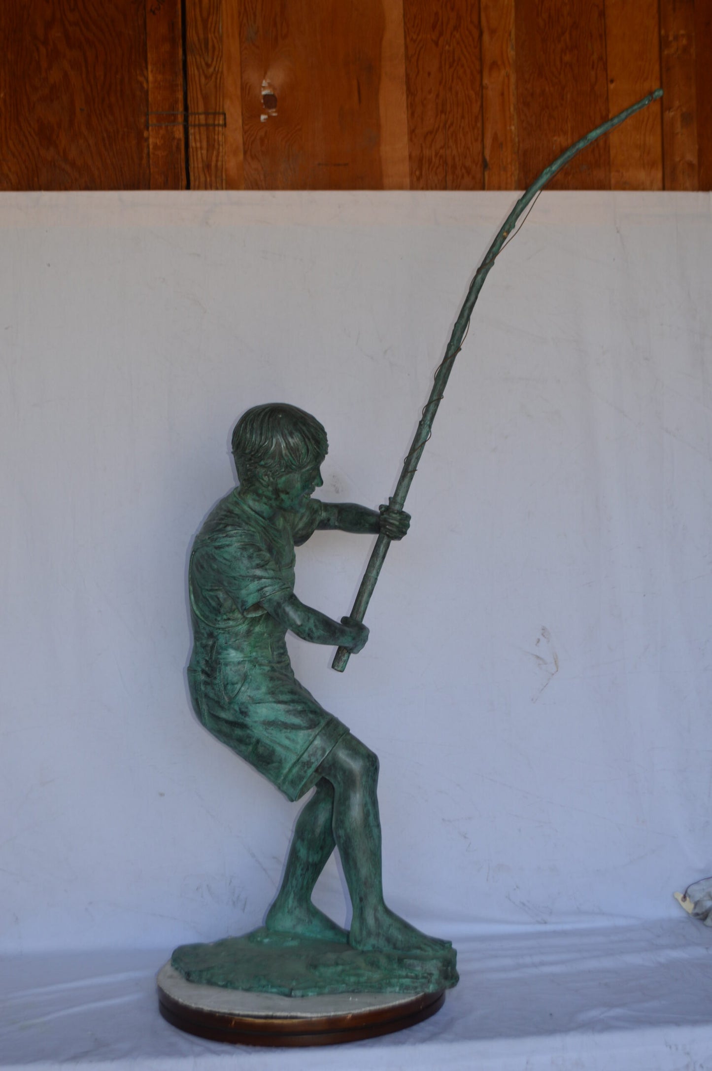 Young Boy Fishing Bronze Statue - green patina - Size: 16"L x 54"W x 62"H.