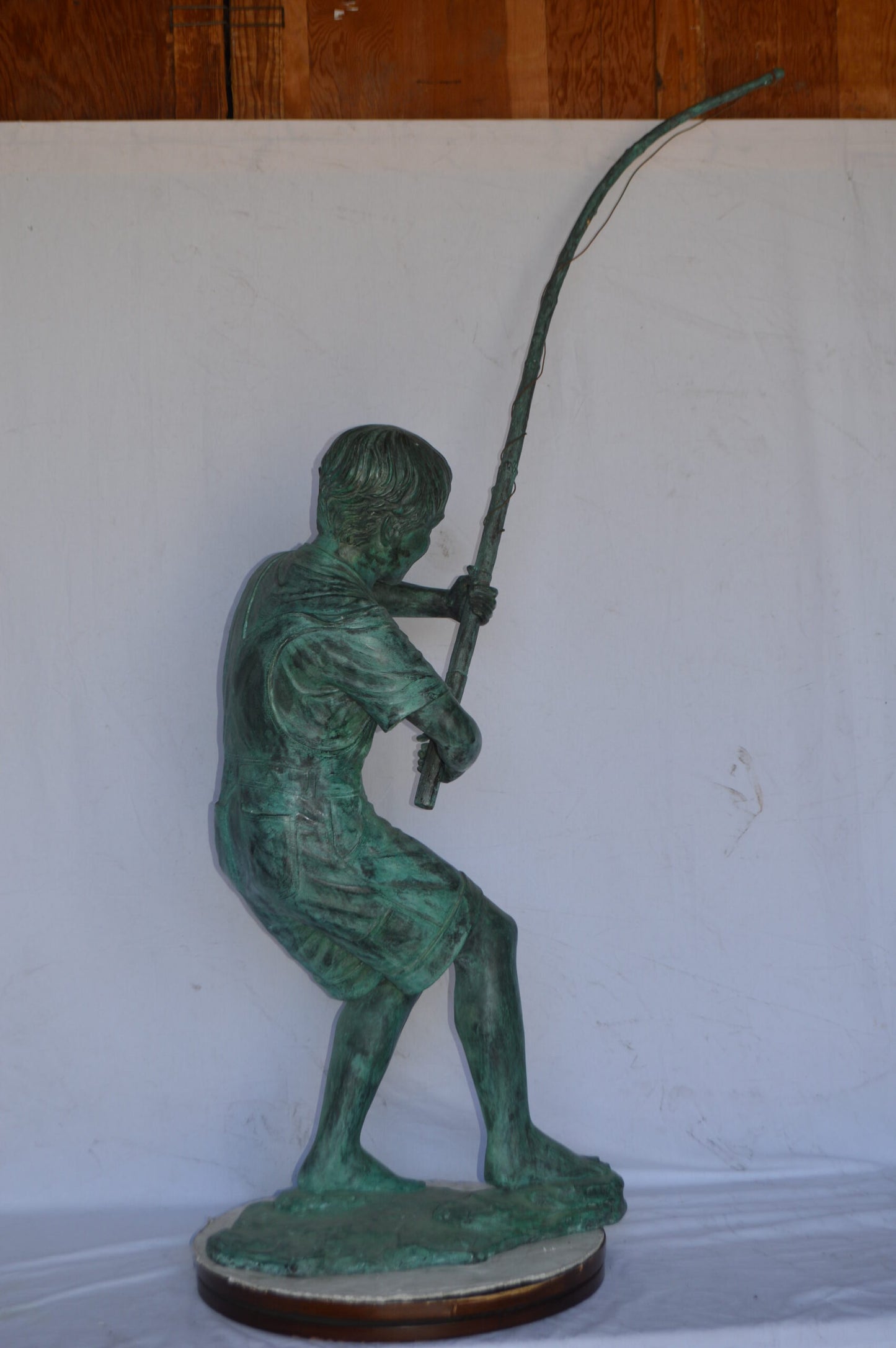 Young Boy Fishing Bronze Statue - green patina - Size: 16"L x 54"W x 62"H.