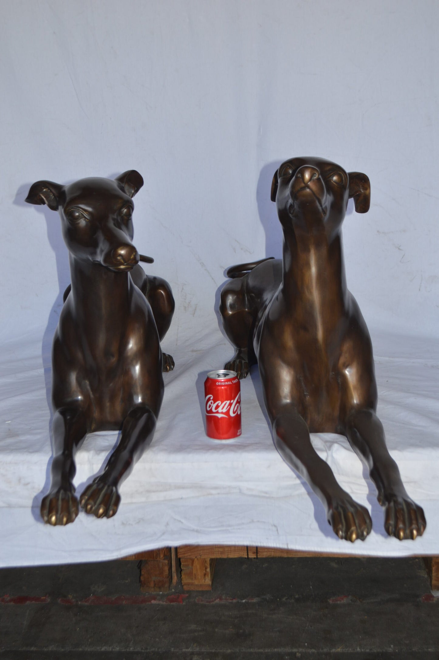 Pair of Greyhound dogs laying down Bronze Statues - Size: 50"L x 11"W x 20"H.