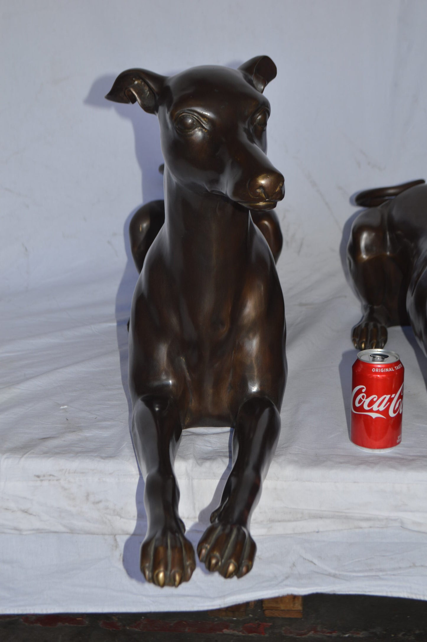 Pair of Greyhound dogs laying down Bronze Statues - Size: 50"L x 11"W x 20"H.