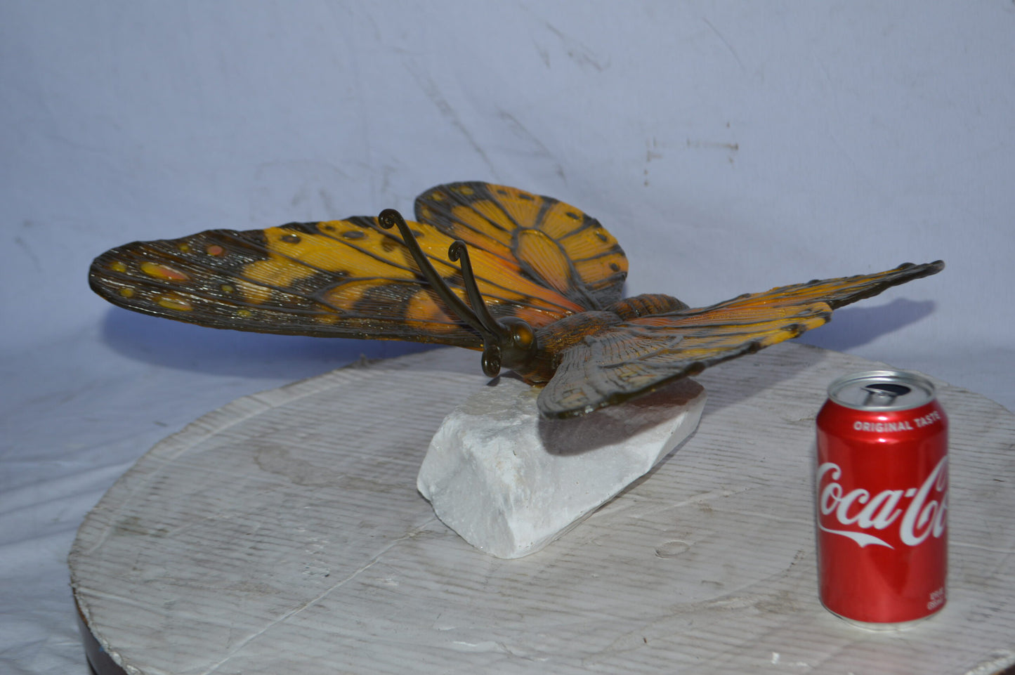 Orange Monarch butterfly bronze statue on a  rock - Size: 14"L x 16"W x 8"H.