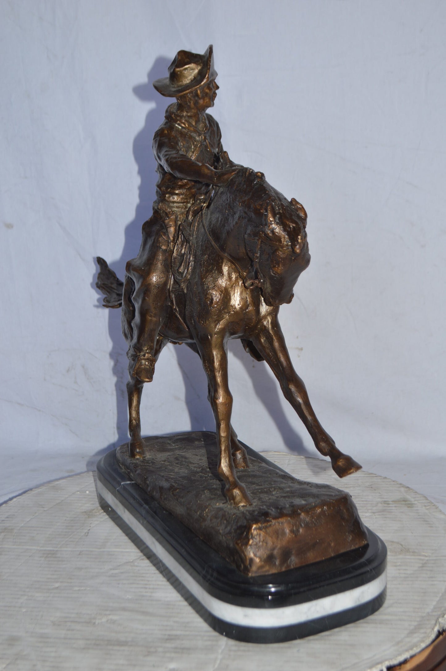 Cowboy Bronze replica by Fredric Remington - Size: 25"L x 9"W x 23"H.