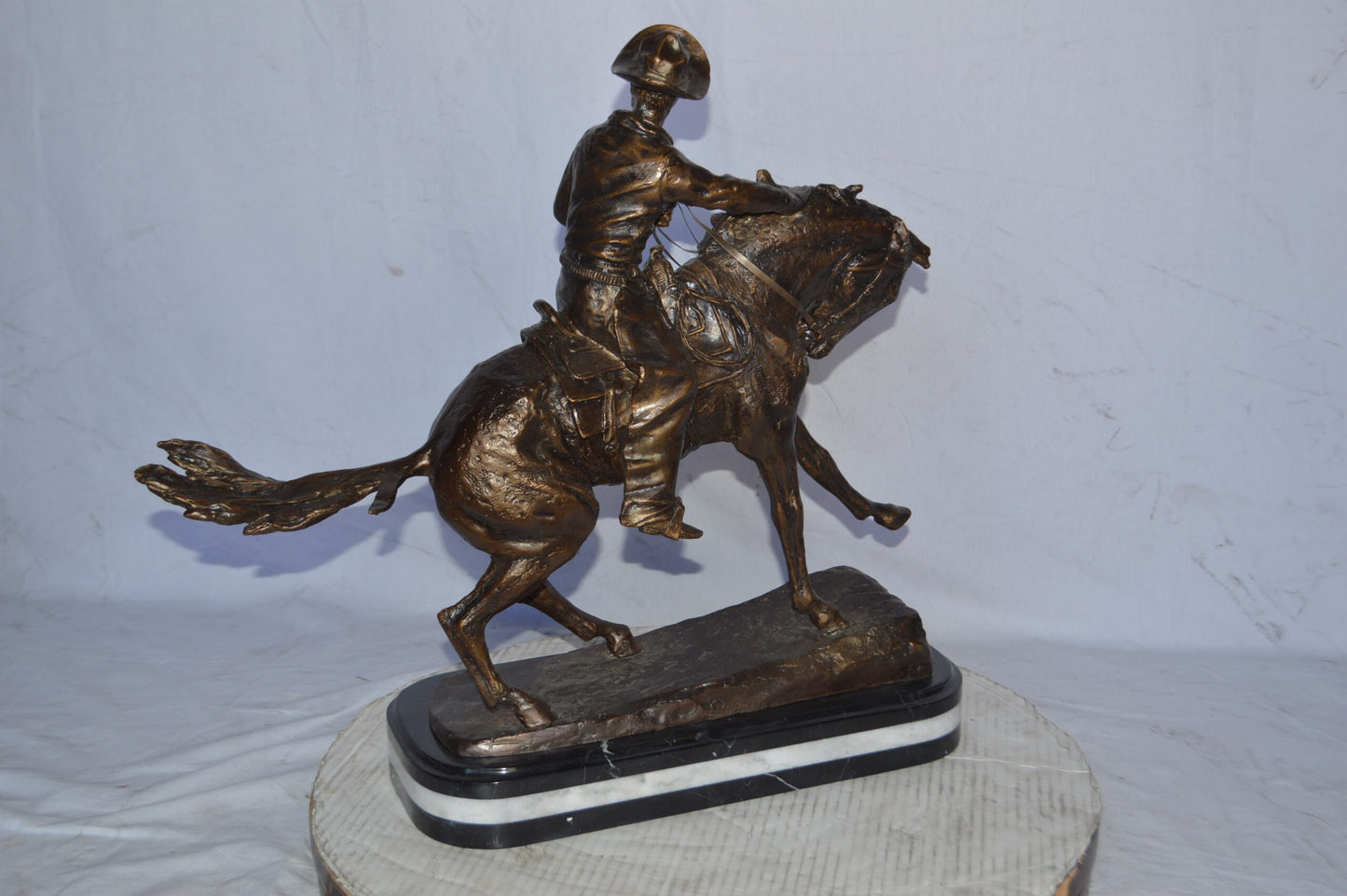 Cowboy Bronze replica by Fredric Remington - Size: 25"L x 9"W x 23"H.