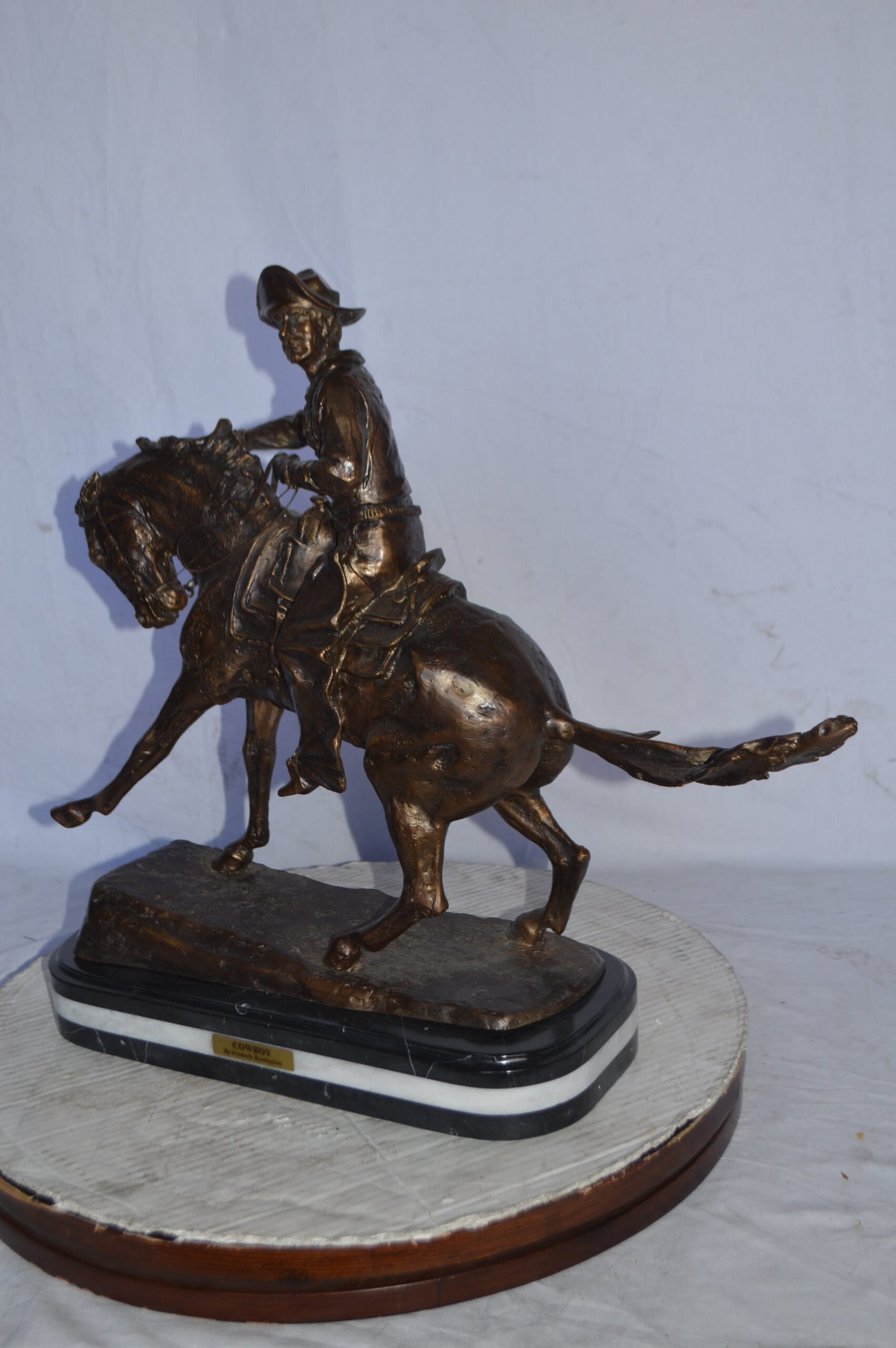 Cowboy Bronze replica by Fredric Remington - Size: 25"L x 9"W x 23"H.