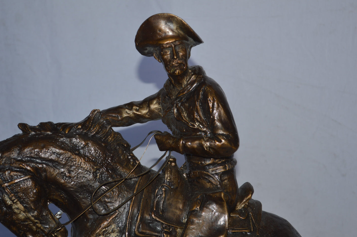 Cowboy Bronze replica by Fredric Remington - Size: 25"L x 9"W x 23"H.