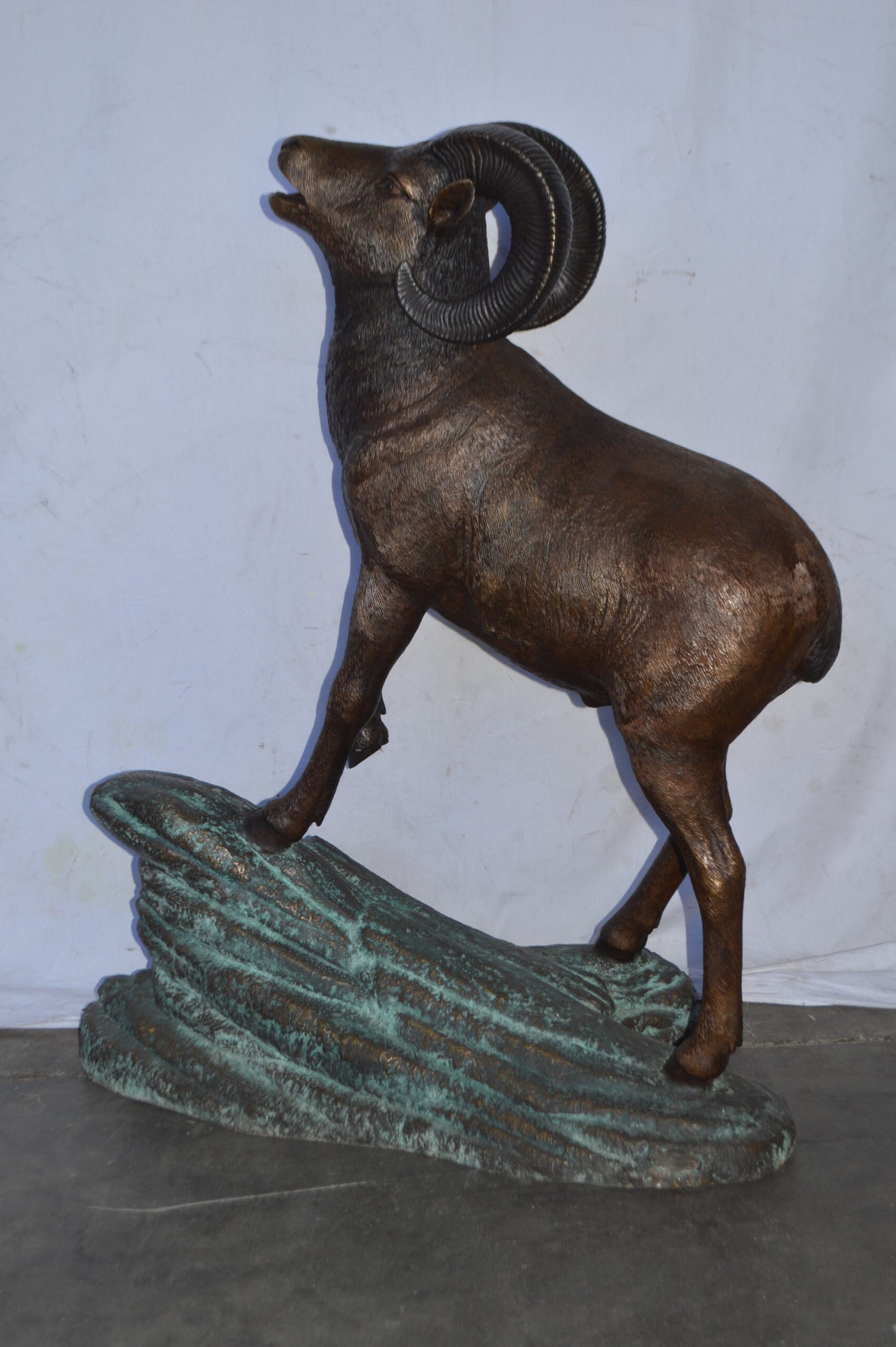 Life Size Ram standing on a rock Bronze Statue - Size: 38"L x 19"W x 45"H.