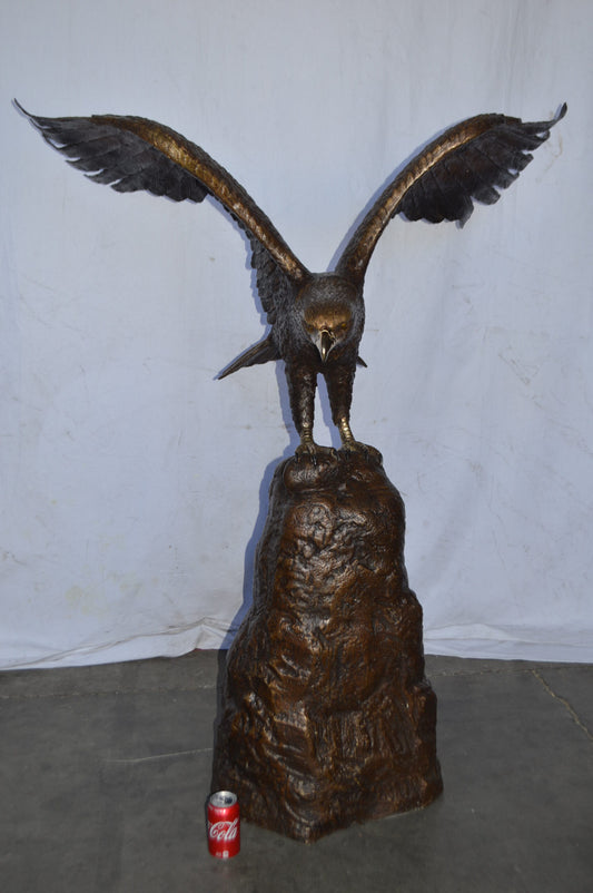 Eagle Landing on a Rock Bronze Statue - Size: 51"L x 36"W x 58"H.