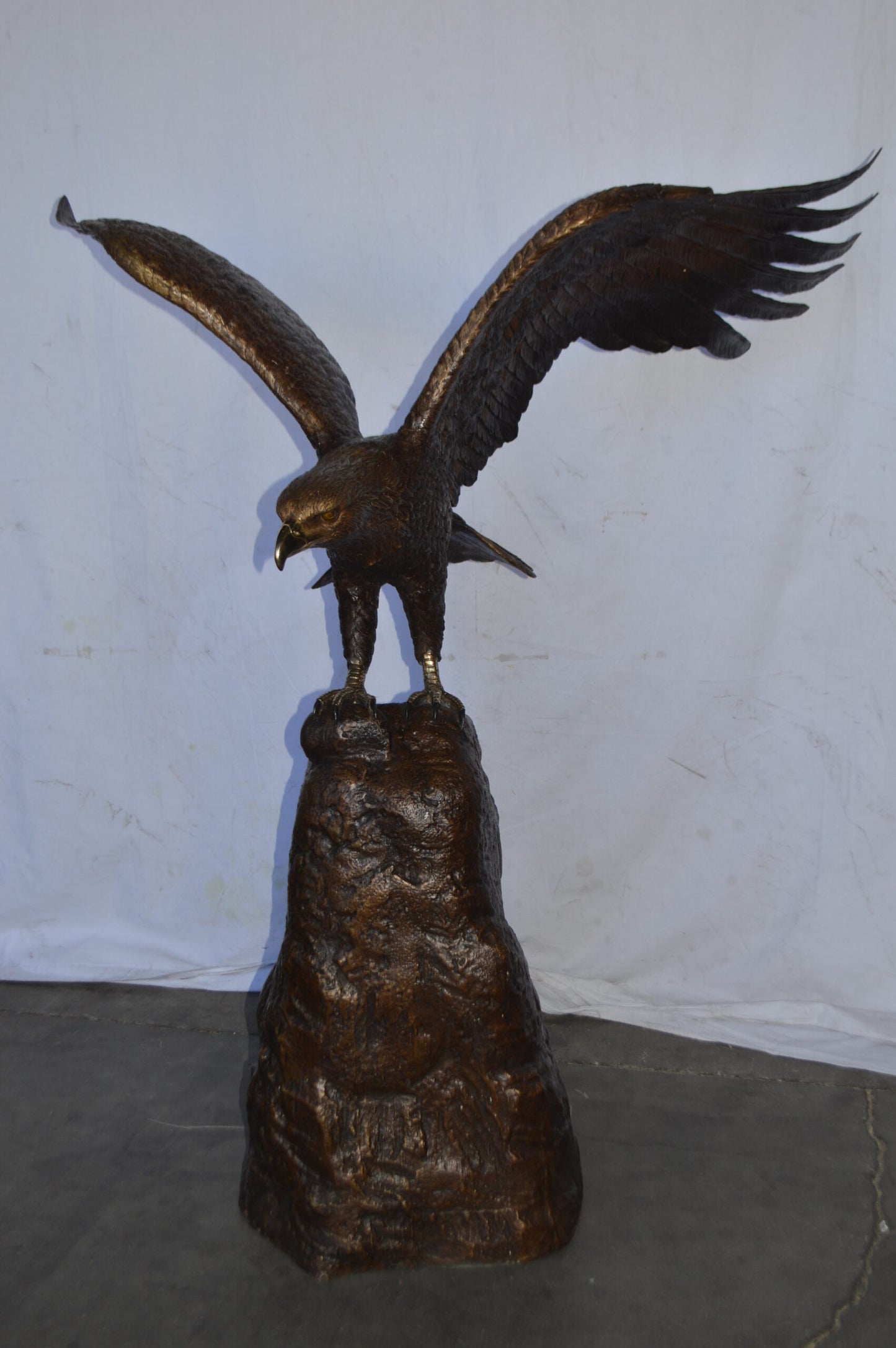 Eagle Landing on a Rock Bronze Statue - Size: 51"L x 36"W x 58"H.