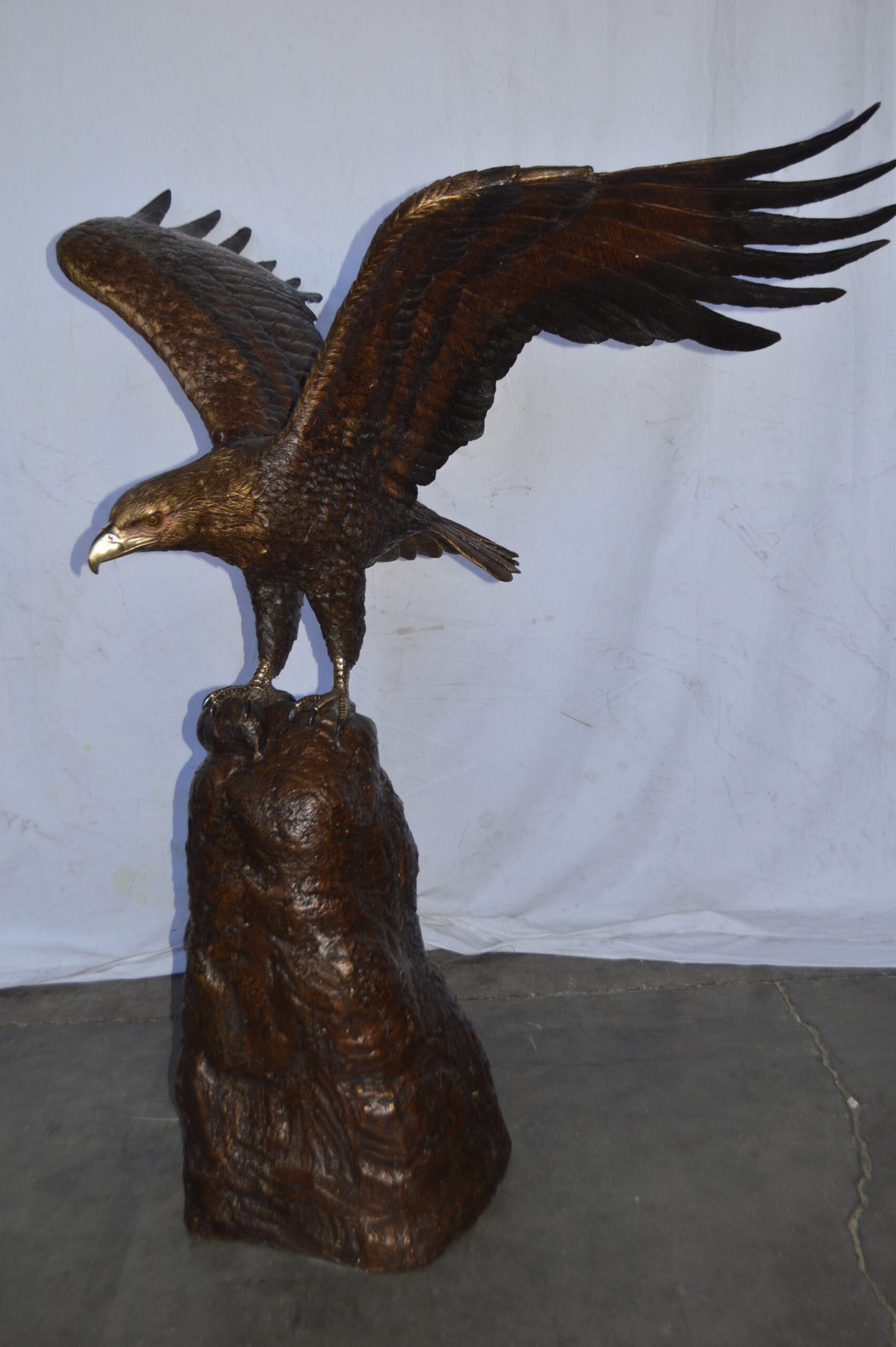 Eagle Landing on a Rock Bronze Statue - Size: 51"L x 36"W x 58"H.