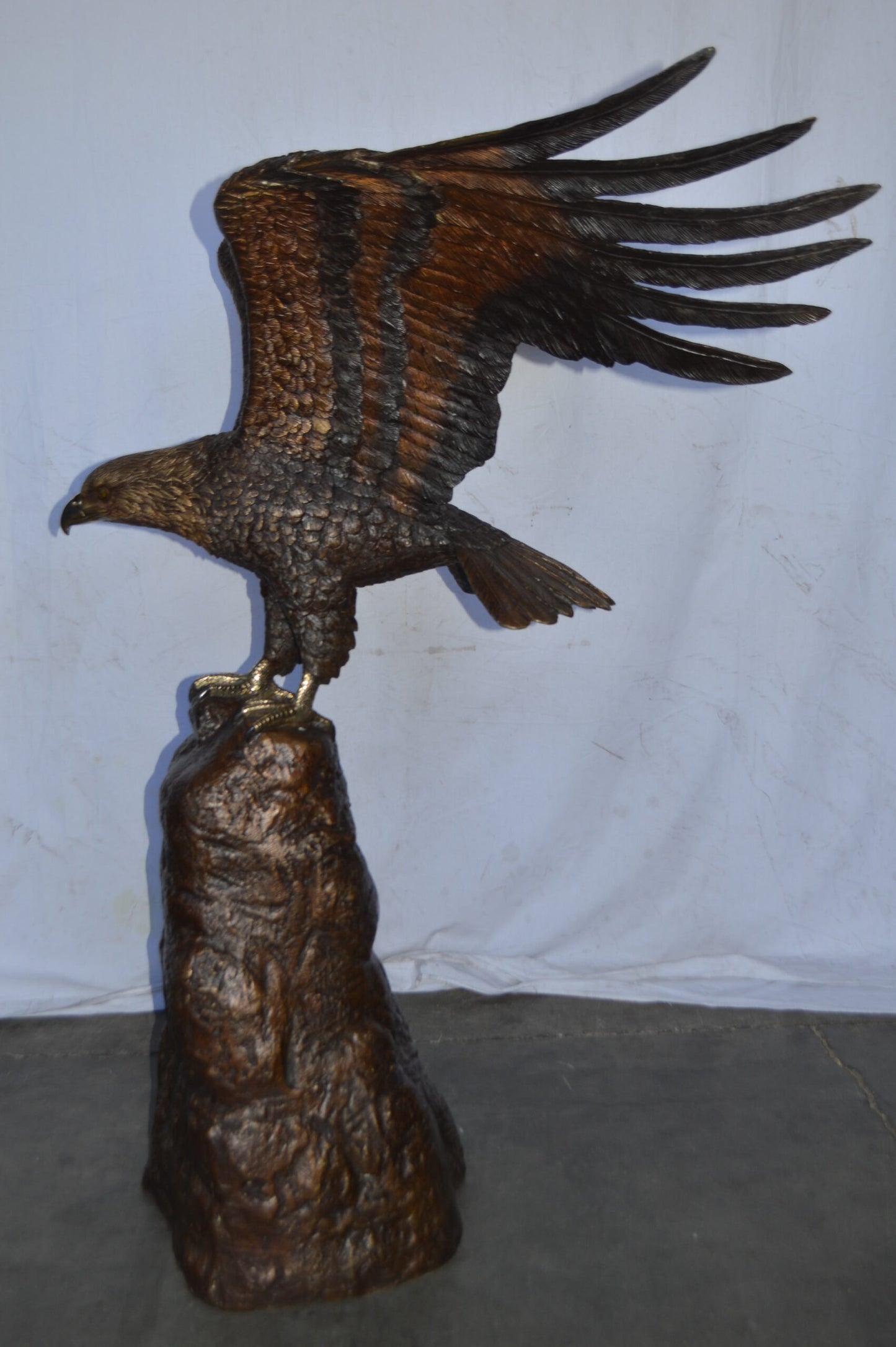 Eagle Landing on a Rock Bronze Statue - Size: 51"L x 36"W x 58"H.