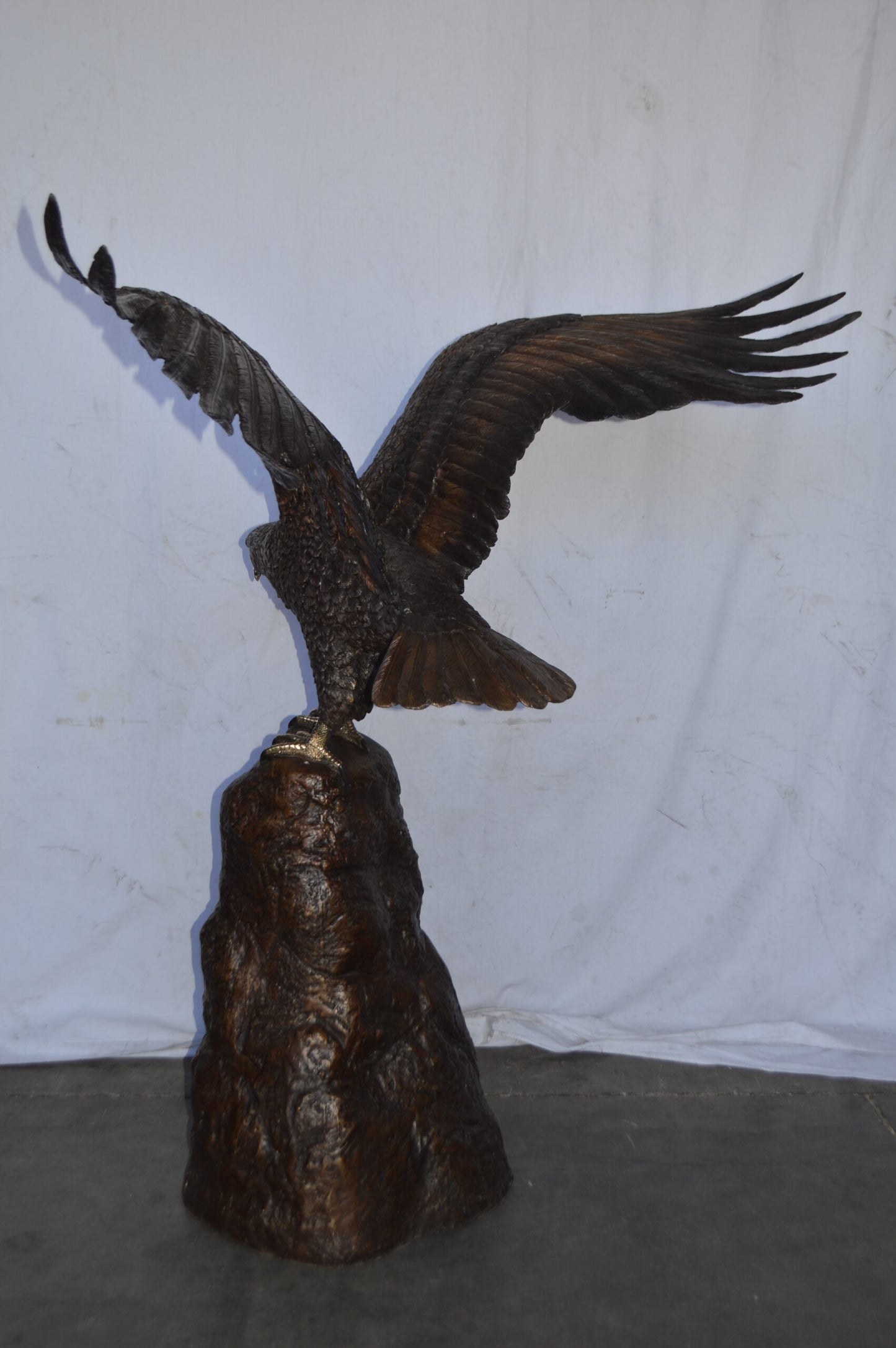 Eagle Landing on a Rock Bronze Statue - Size: 51"L x 36"W x 58"H.