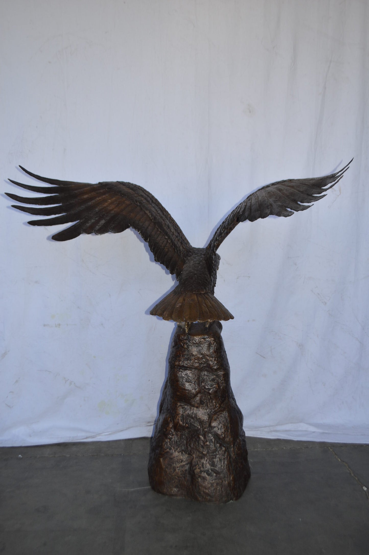 Eagle Landing on a Rock Bronze Statue - Size: 51"L x 36"W x 58"H.