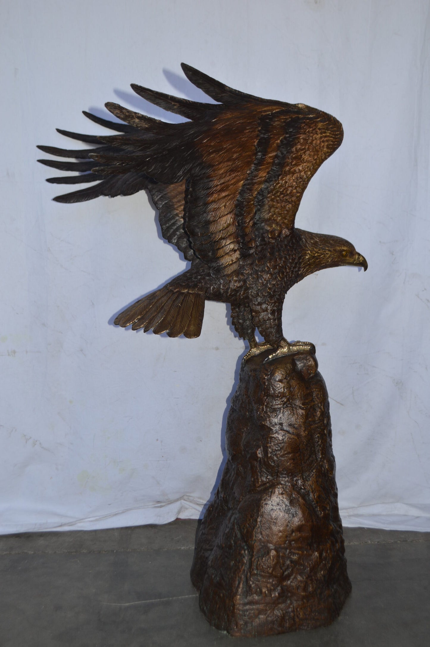 Eagle Landing on a Rock Bronze Statue - Size: 51"L x 36"W x 58"H.