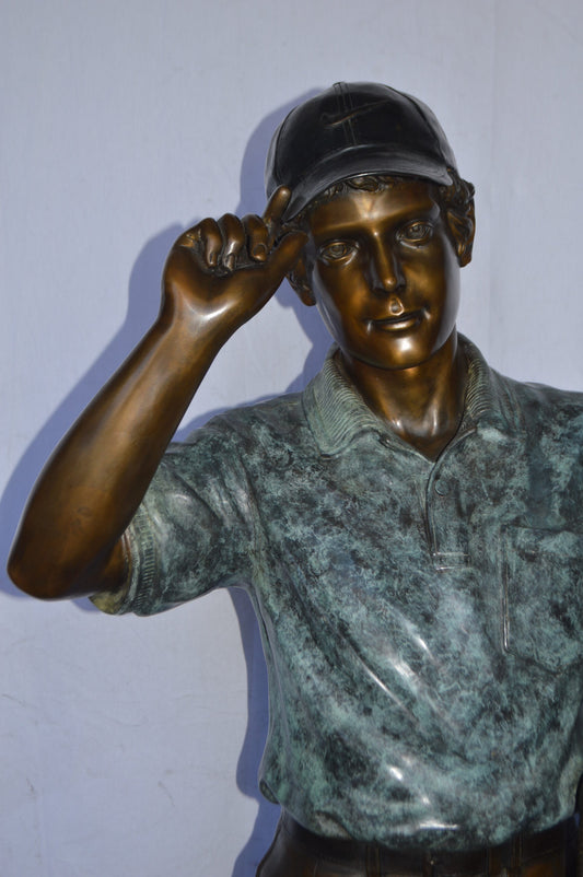 Golfer standing with his gear large bronze Statue - Size: 34"L x 21"W x 65"H.