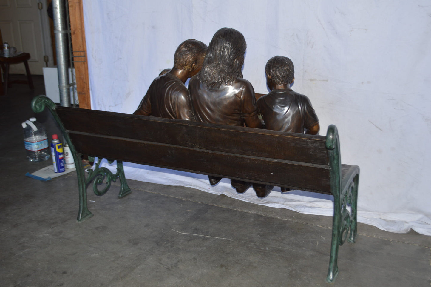 Mom and boys reading stories on bench bronze statue - Size: 53"L x 33"W x 39"H.