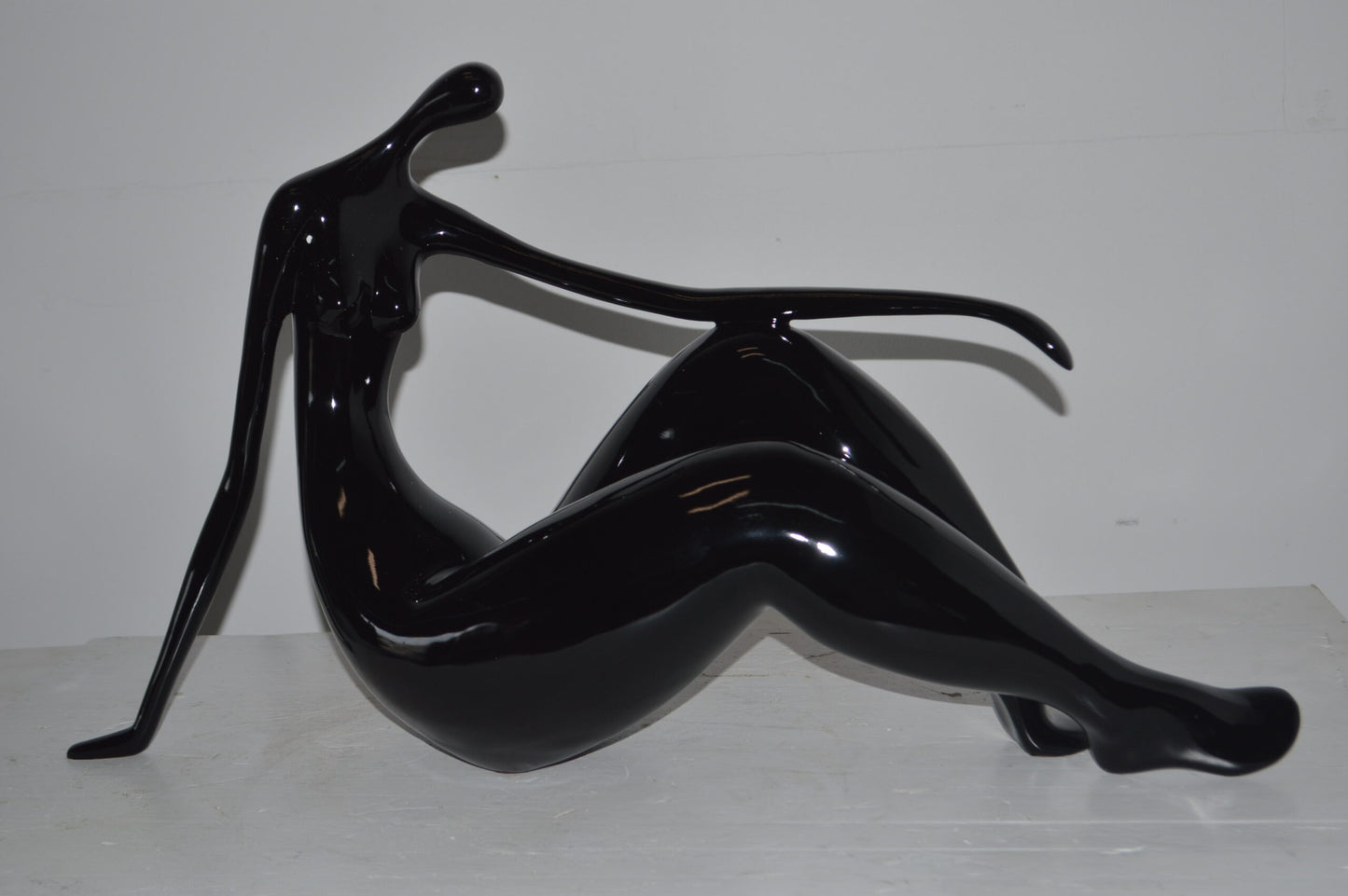 Modern Art Women on the Beach Black Resin Statue - Size: 28"L x 8"W x 16"H.