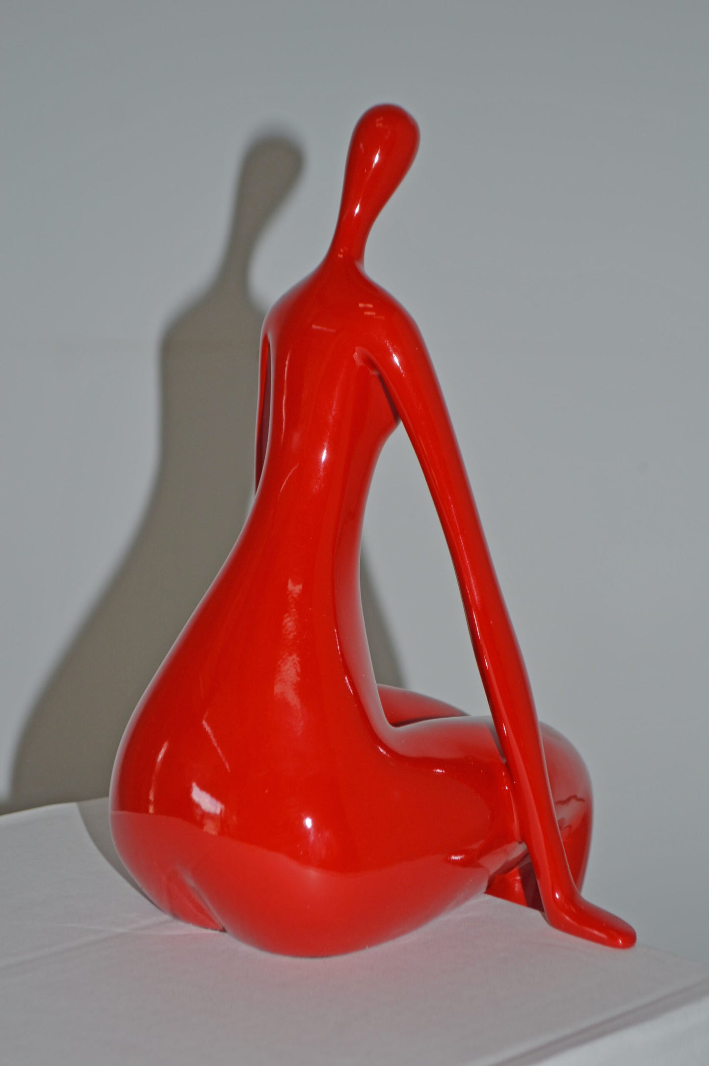 Modern Art Red Sitting on Edge Girl Made of Resin - Size: 8"L x 6"W x 15"H.
