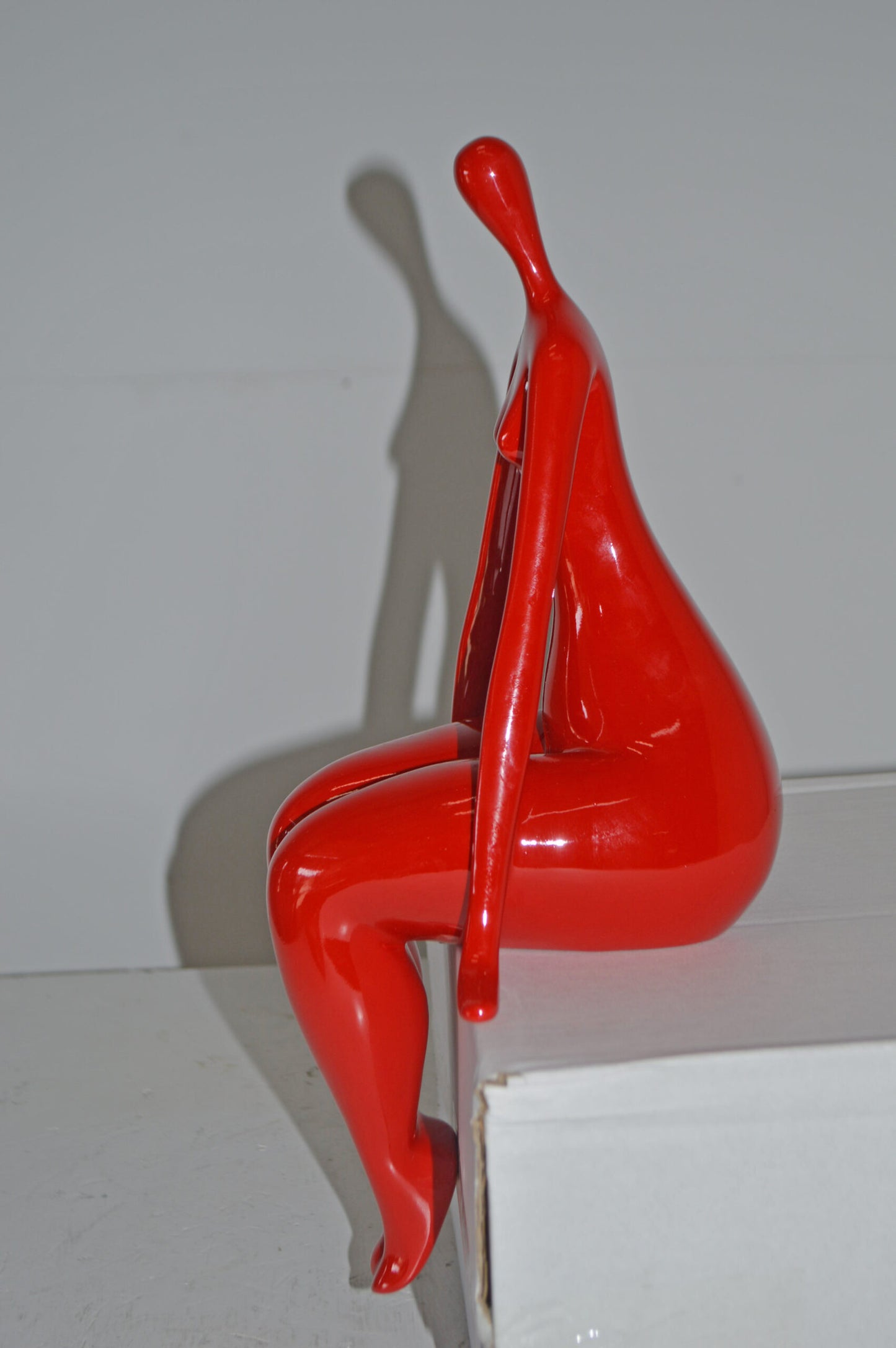 Modern Art Red Sitting on Edge Girl Made of Resin - Size: 8"L x 6"W x 15"H.