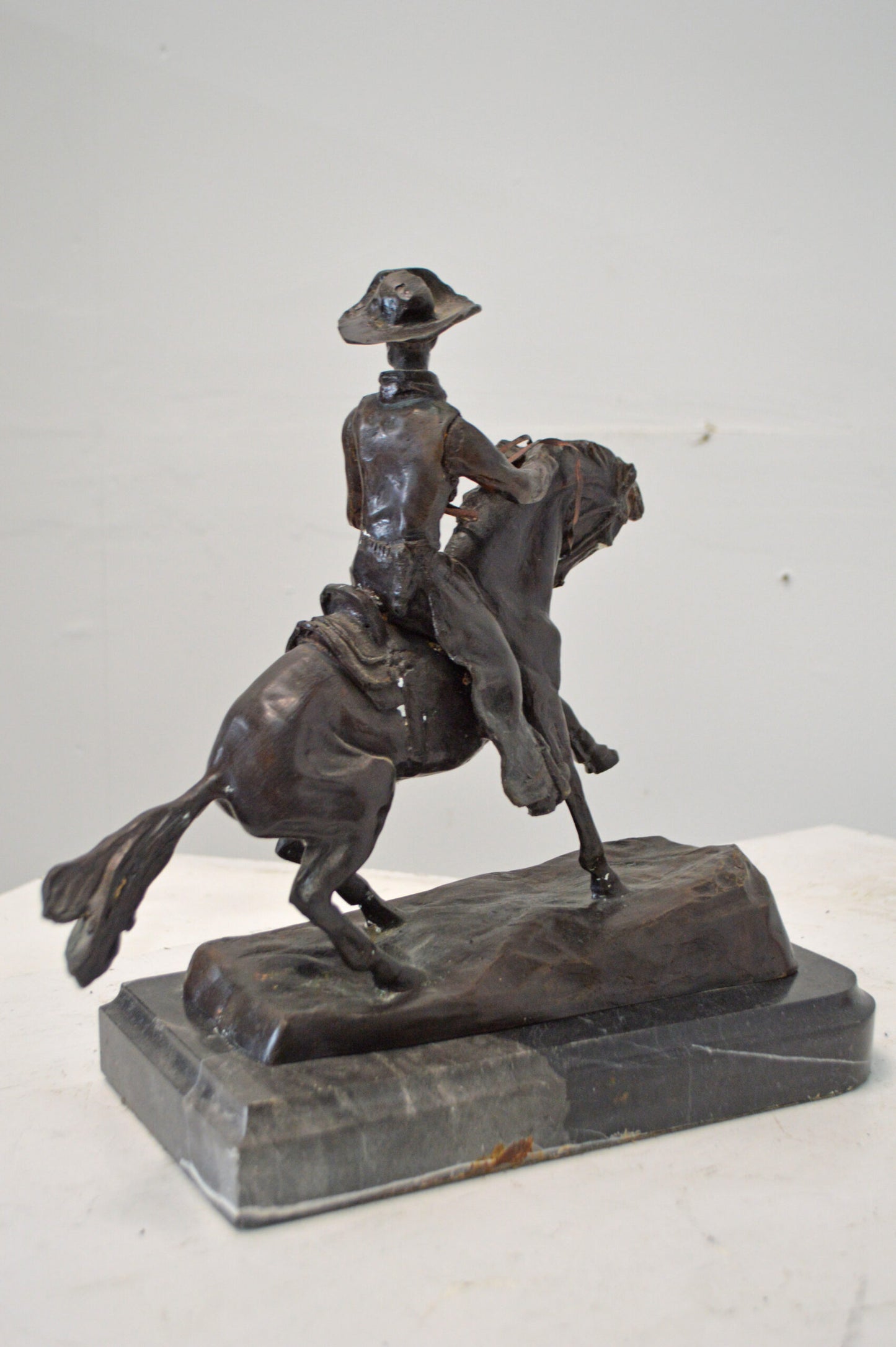 Cowboy, a Frederic Remington Replica Bronze Statue - Size: 14"L x 8"W x 13"H.
