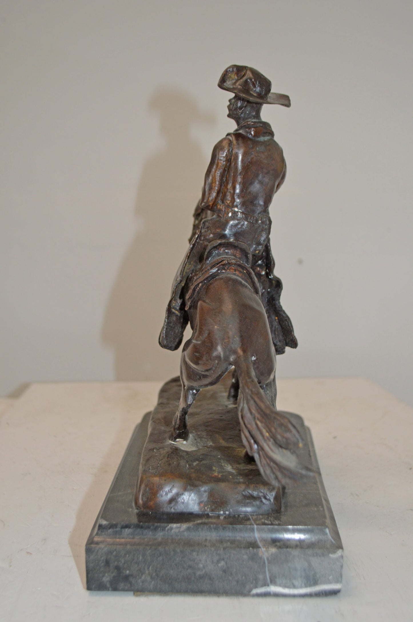 Cowboy, a Frederic Remington Replica Bronze Statue - Size: 14"L x 8"W x 13"H.