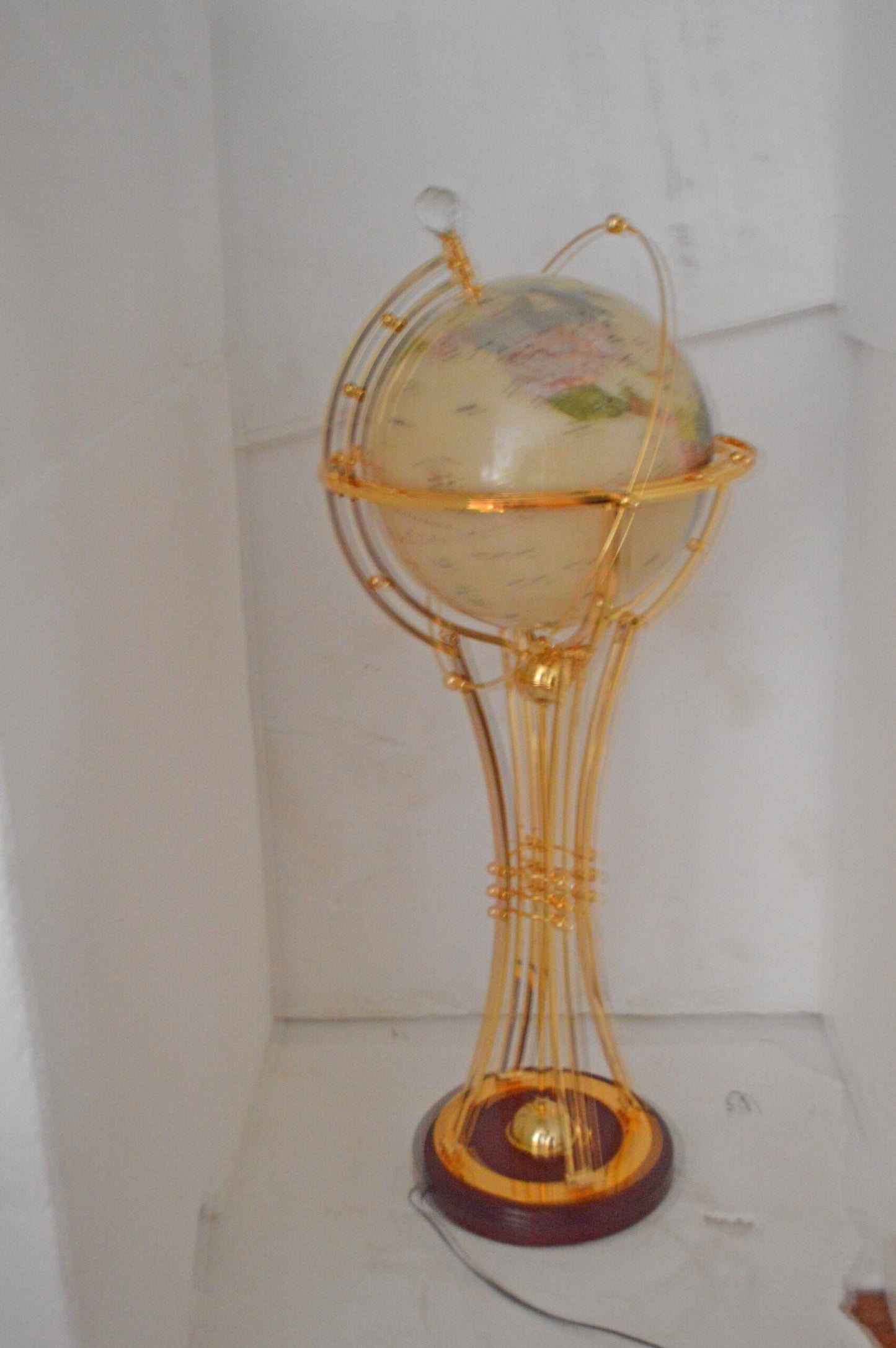 Illuminated White Gold World Globe Rotated by motor - Size: 19"L x 19"W x 42"H.