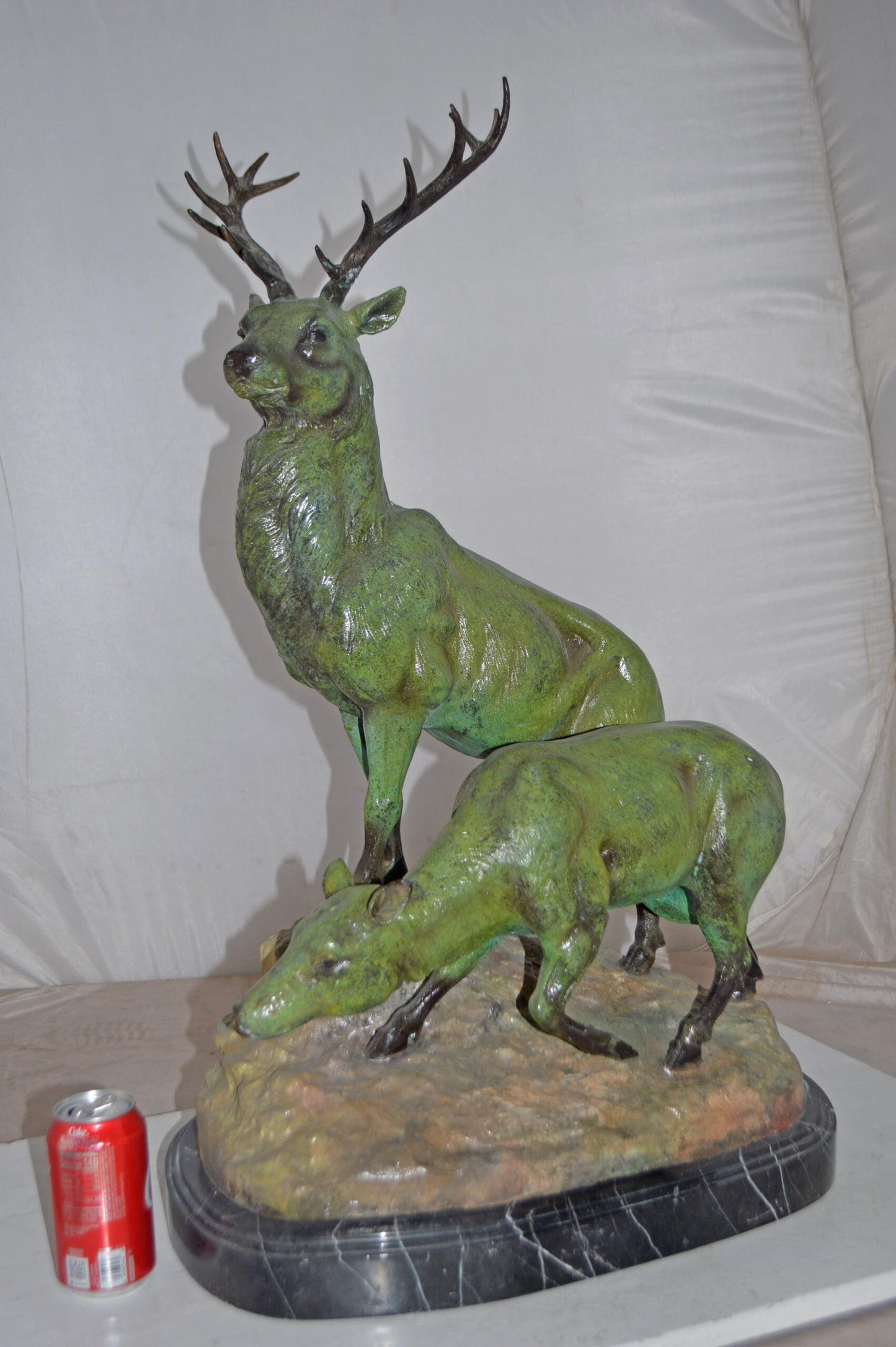 Two Deers Bronze Statue with a Green patina finish - Size: 15"L x 22"W x 32"H.