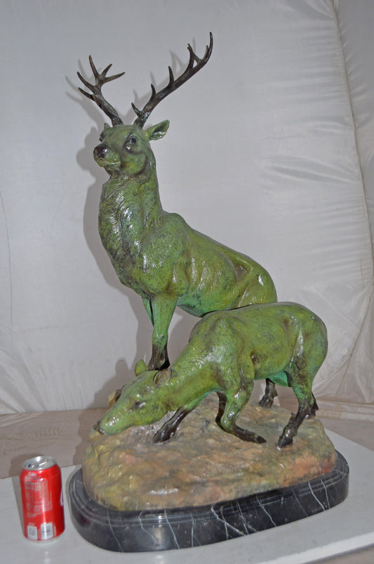 Two Deers Bronze Statue with a Green patina finish - Size: 15"L x 22"W x 32"H.