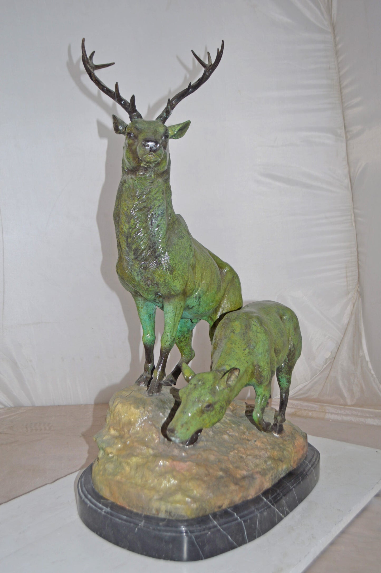 Two Deers Bronze Statue with a Green patina finish - Size: 15"L x 22"W x 32"H.