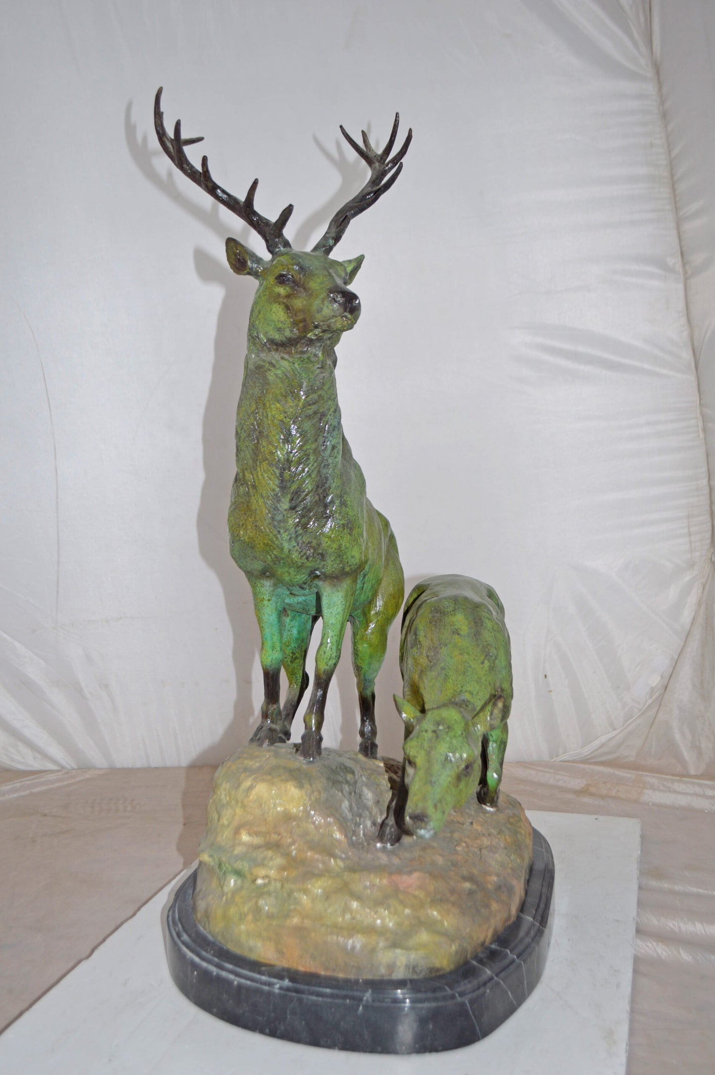 Two Deers Bronze Statue with a Green patina finish - Size: 15"L x 22"W x 32"H.