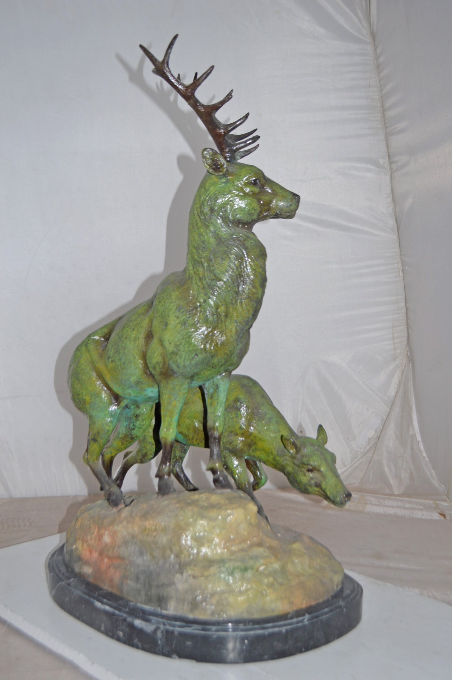 Two Deers Bronze Statue with a Green patina finish - Size: 15"L x 22"W x 32"H.