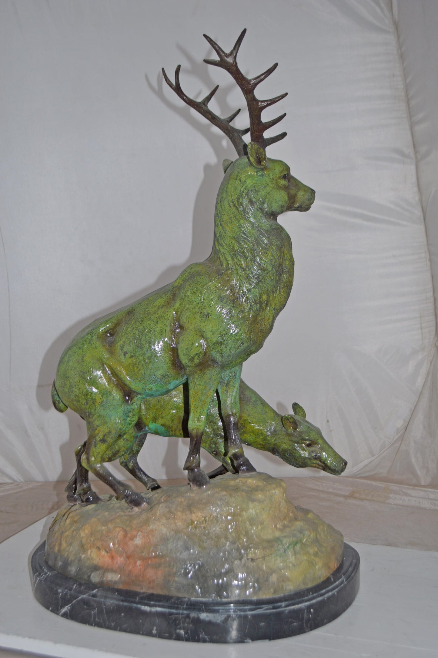 Two Deers Bronze Statue with a Green patina finish - Size: 15"L x 22"W x 32"H.