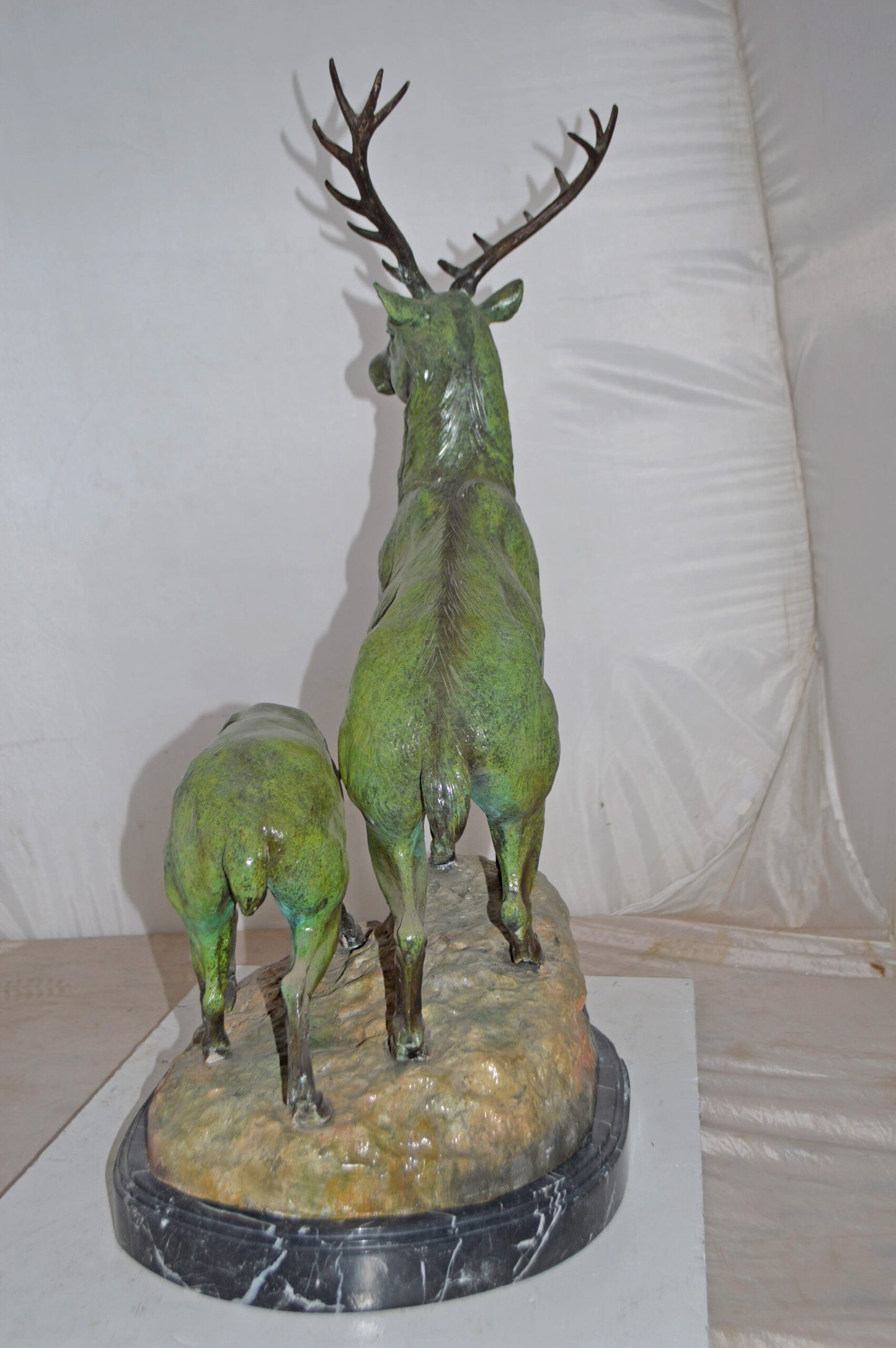 Two Deers Bronze Statue with a Green patina finish - Size: 15"L x 22"W x 32"H.