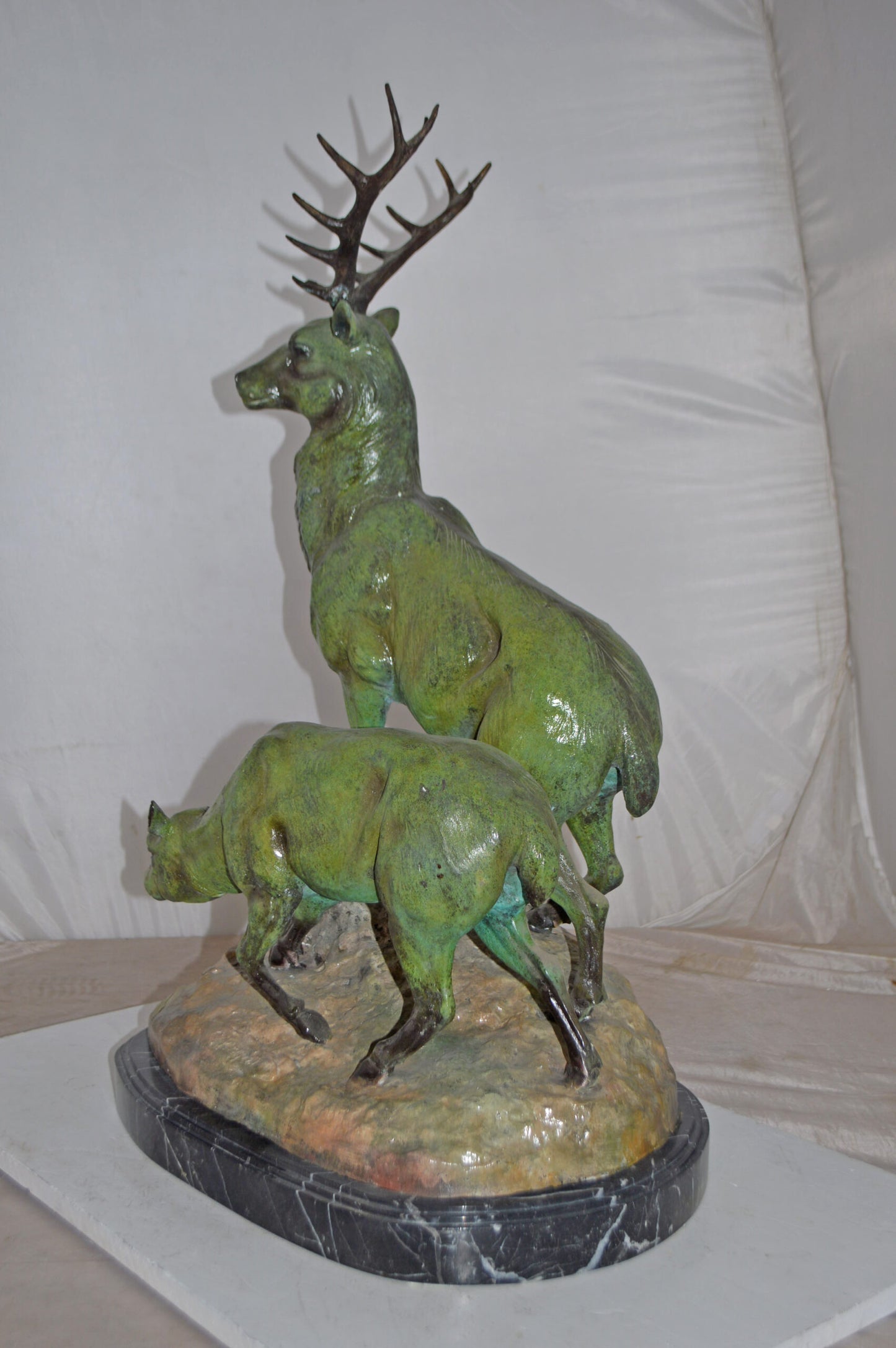 Two Deers Bronze Statue with a Green patina finish - Size: 15"L x 22"W x 32"H.