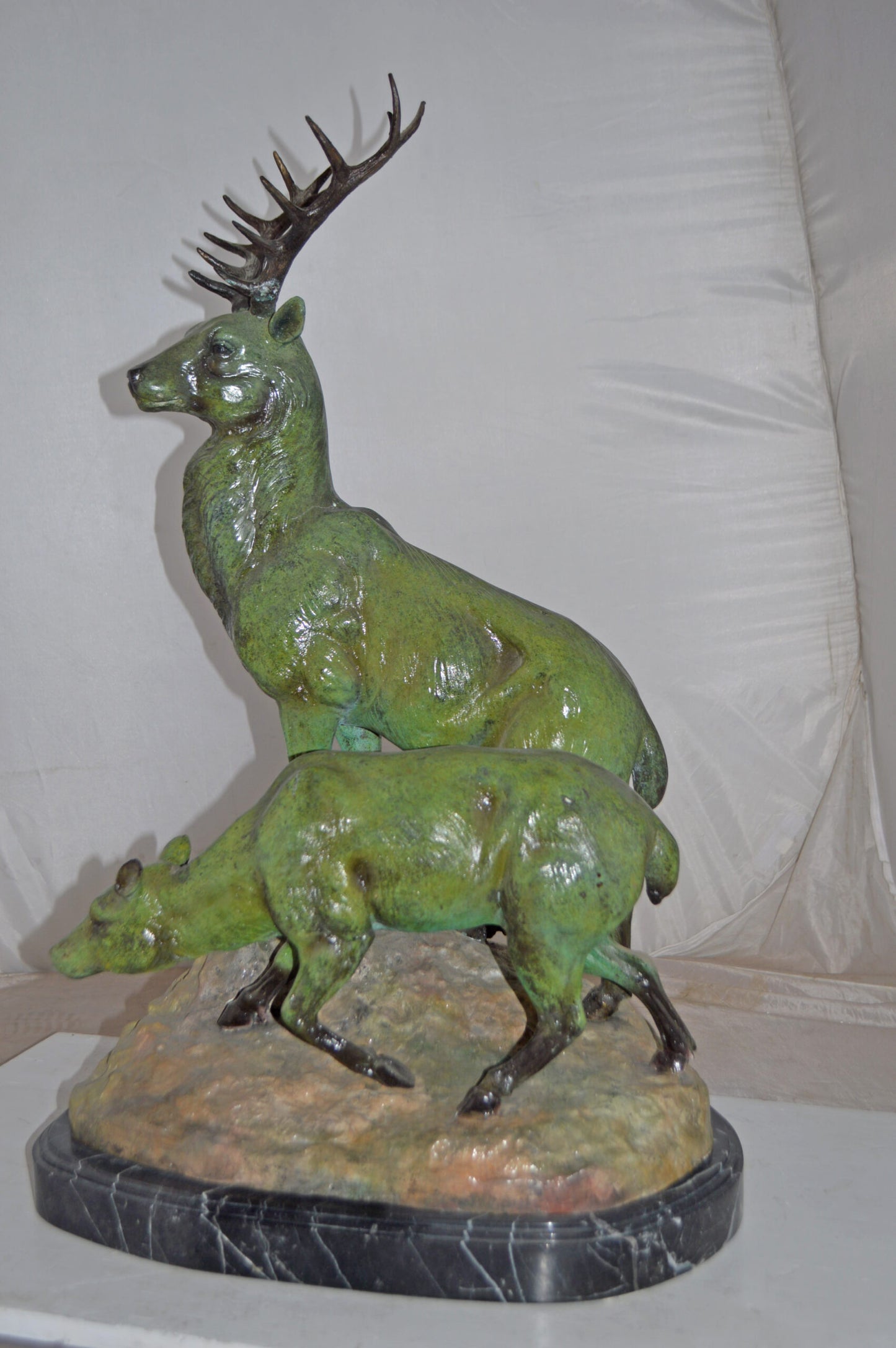 Two Deers Bronze Statue with a Green patina finish - Size: 15"L x 22"W x 32"H.