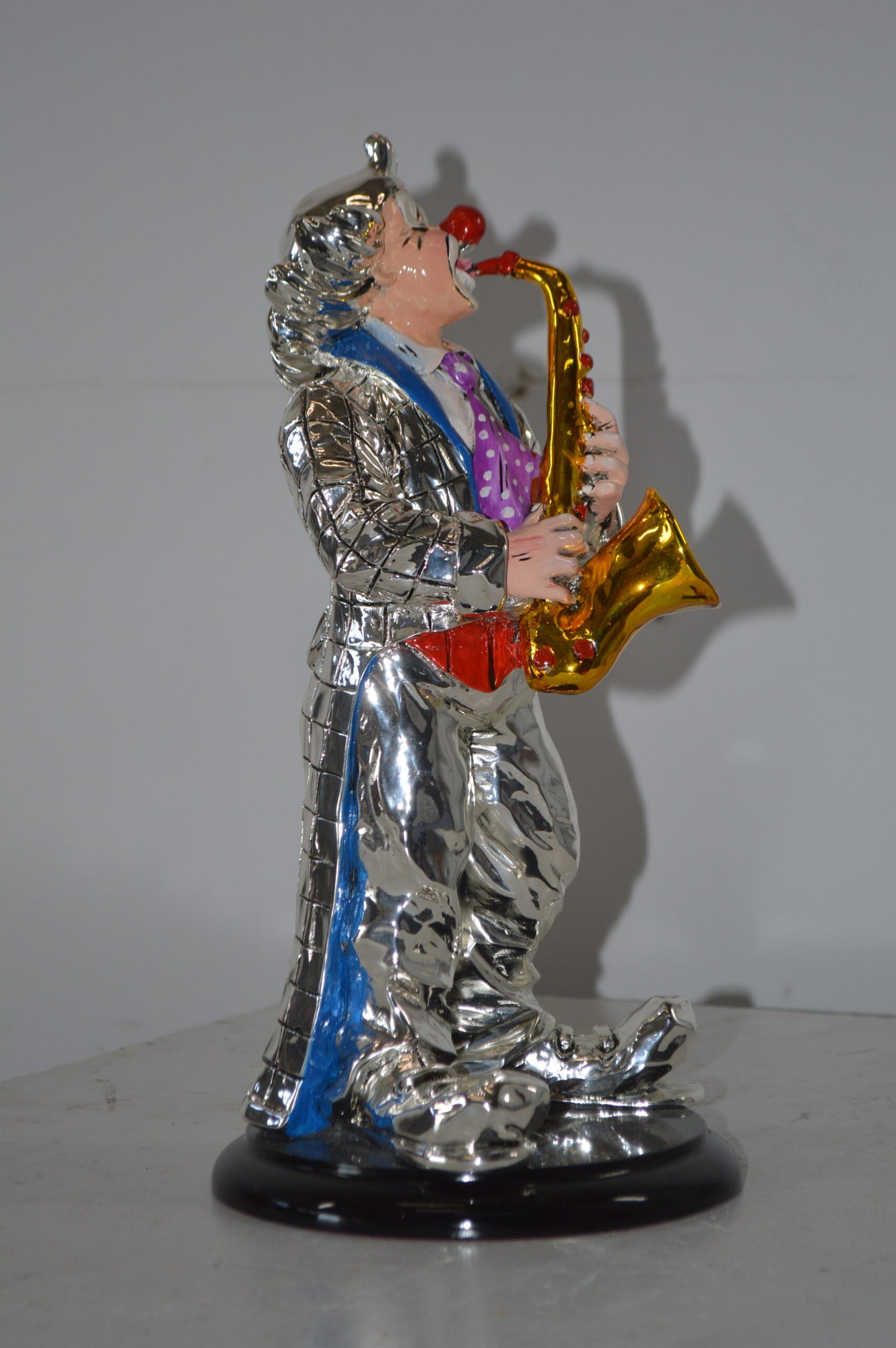 Clown Plays the Saxophone Resin Statue Silver finish - Size: 6"L x 6"W x 14"H.