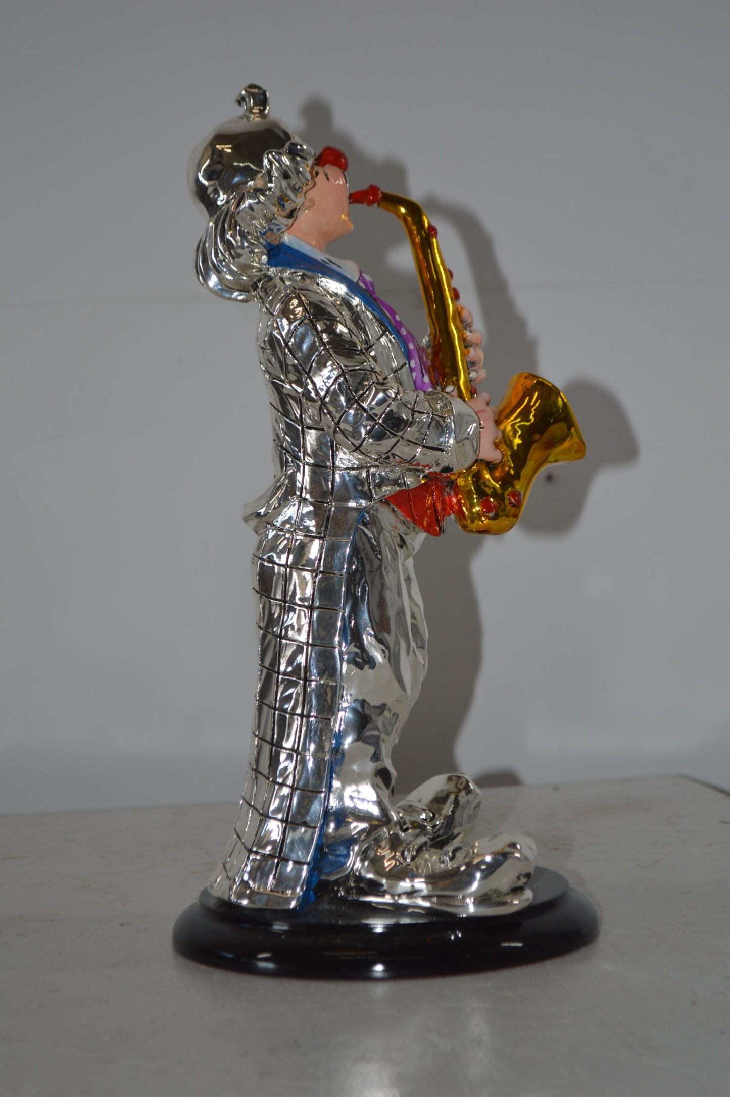 Clown Plays the Saxophone Resin Statue Silver finish - Size: 6"L x 6"W x 14"H.
