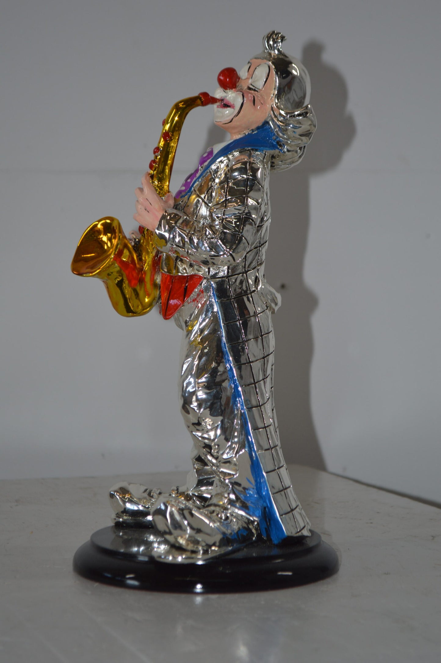 Clown Plays the Saxophone Resin Statue Silver finish - Size: 6"L x 6"W x 14"H.
