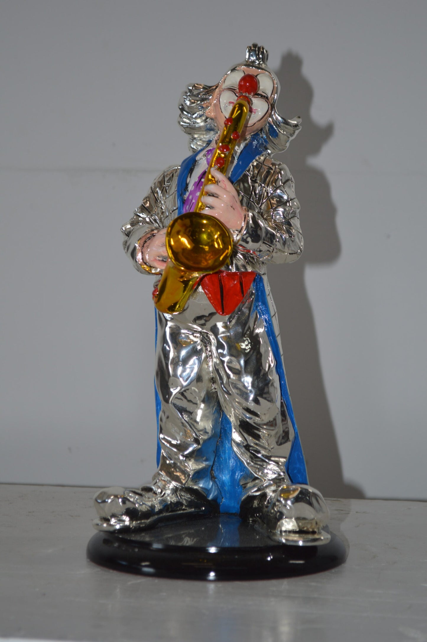Clown Plays the Saxophone Resin Statue Silver finish - Size: 6"L x 6"W x 14"H.