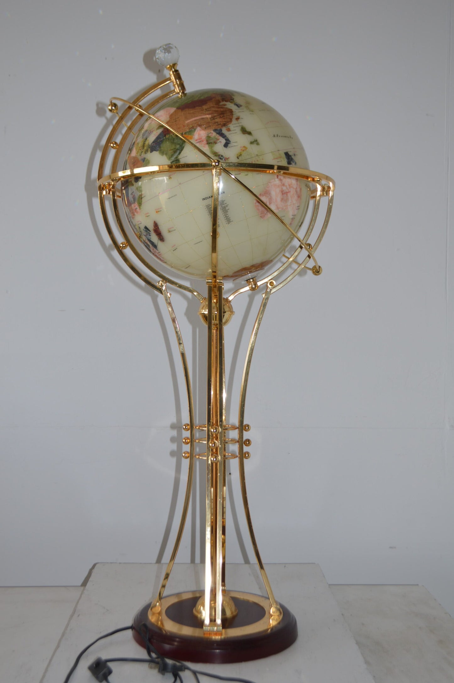 Illuminated White Gold World Globe Rotated by motor - Size: 19"L x 19"W x 42"H.