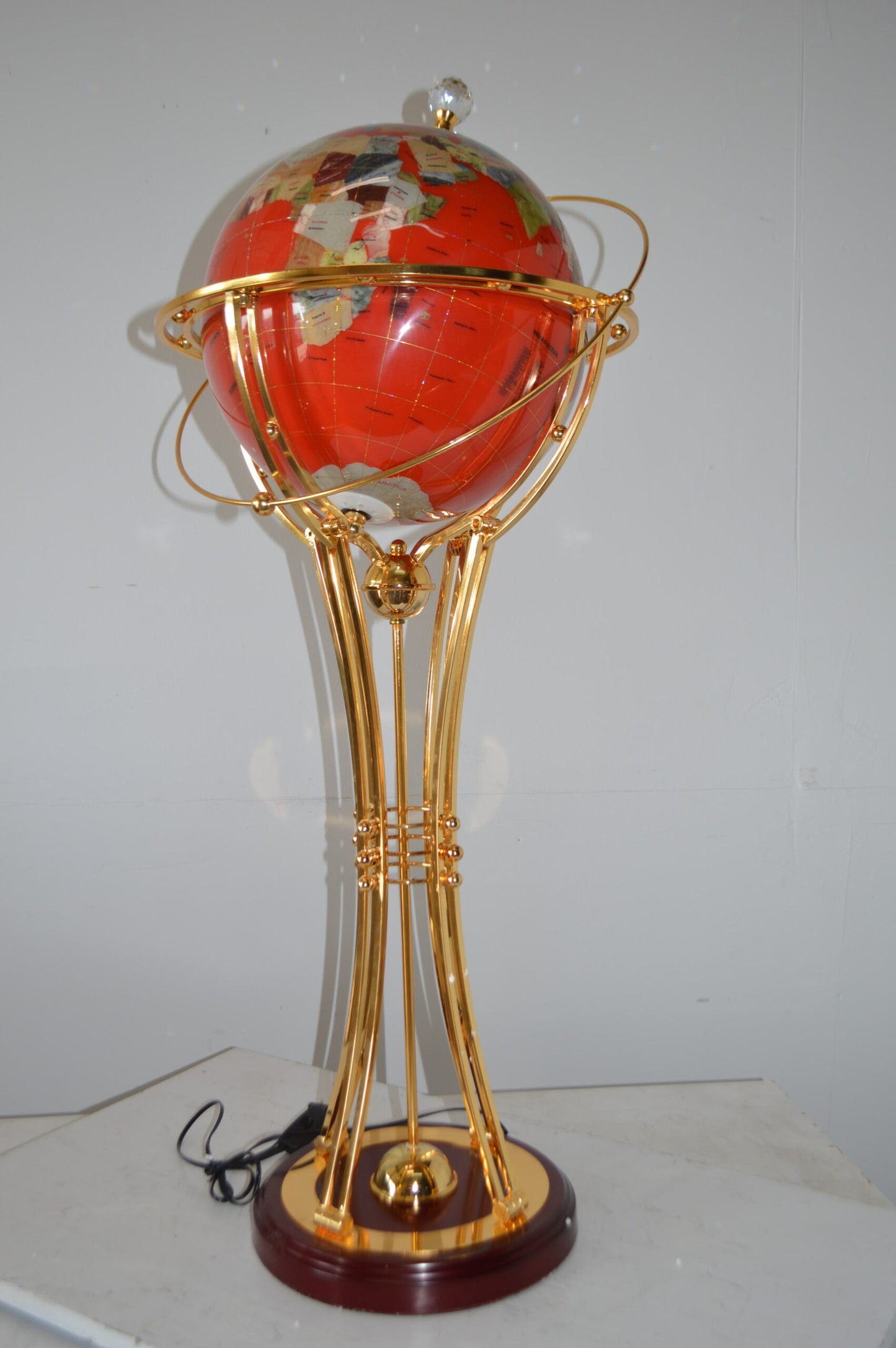 Illuminated Red - Gold World Globe Rotated by motor - Size: 19"L x 19"W x 42"H.
