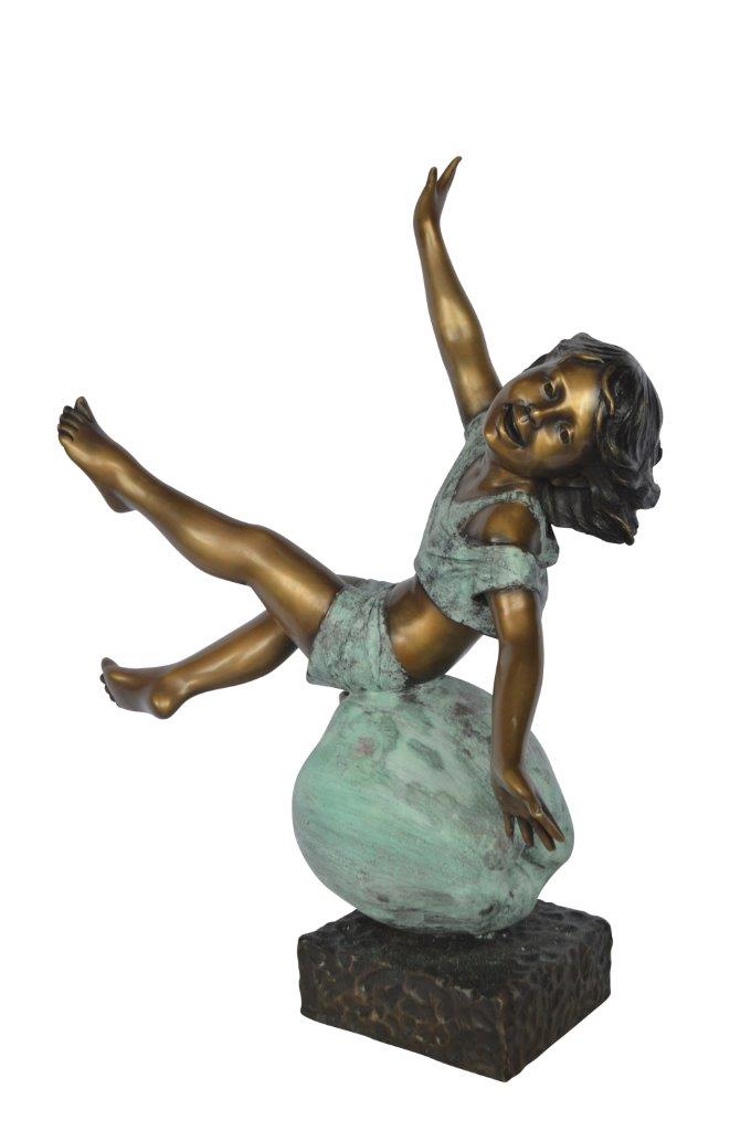 Girl having fun on apple bronze statue -  Size: 22"L x 9"W x 31"H.