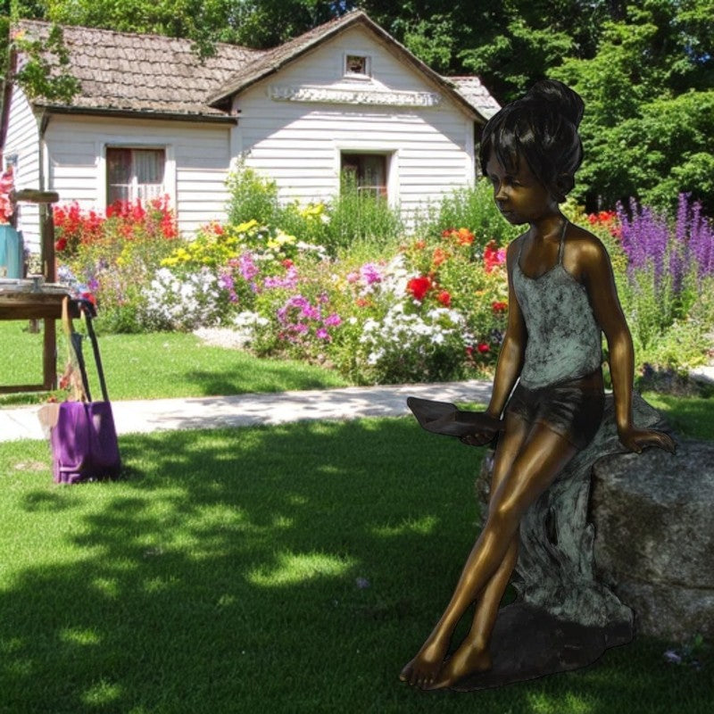 Girl sitting and reading a book bronze statue - Size: 19"L x 15"W x 36"H.