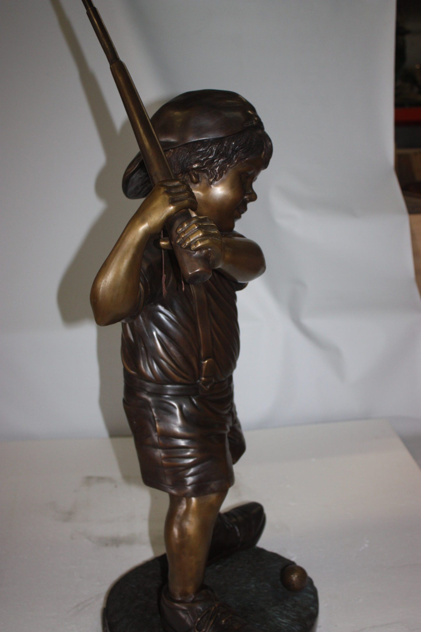 Golfer Boy Bronze - Big shoes - Size: 18"L x 14"W x 49"H.