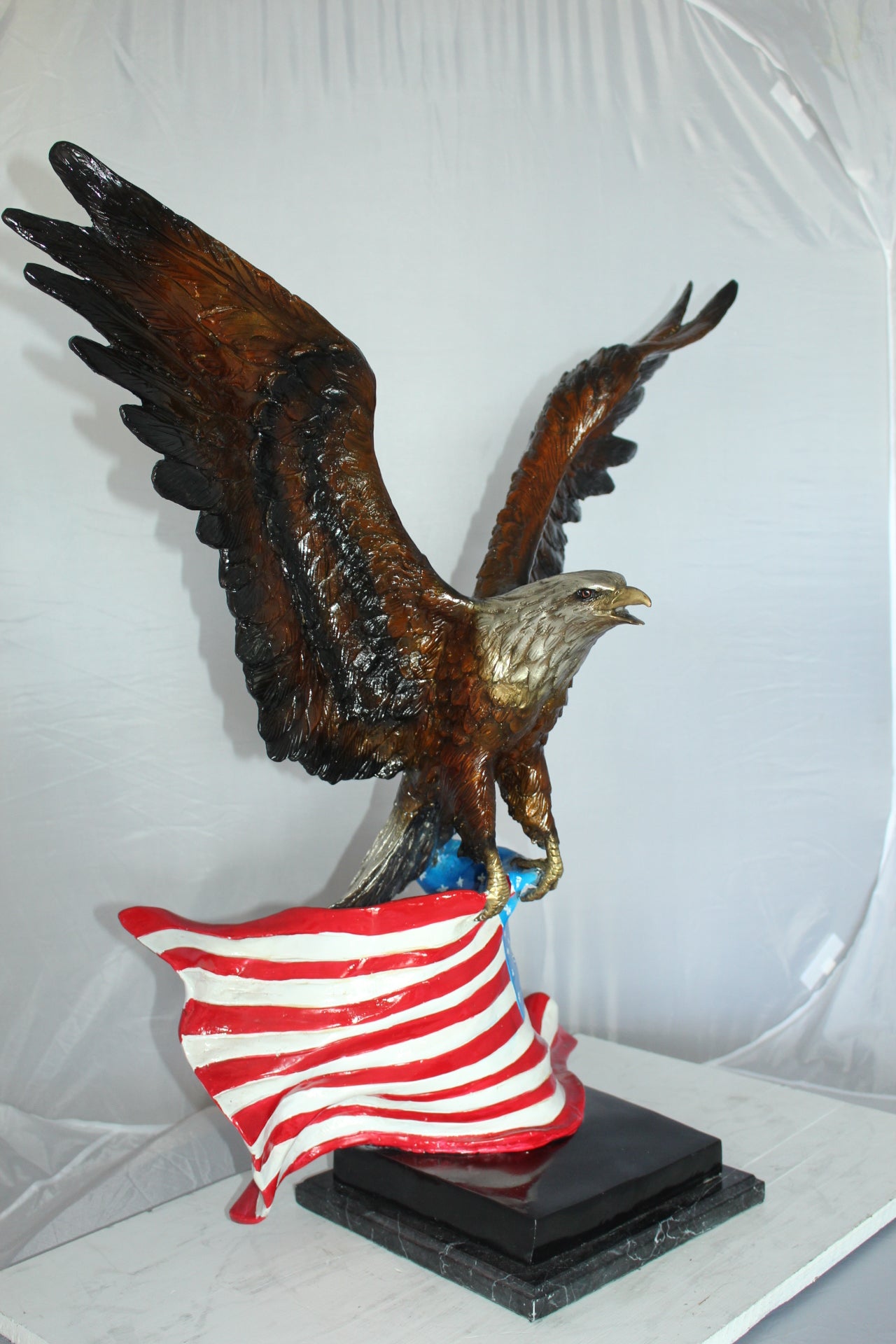 Eagle with American Flag Bronze Statue - Size: 32"L x 14"W x 35"H.