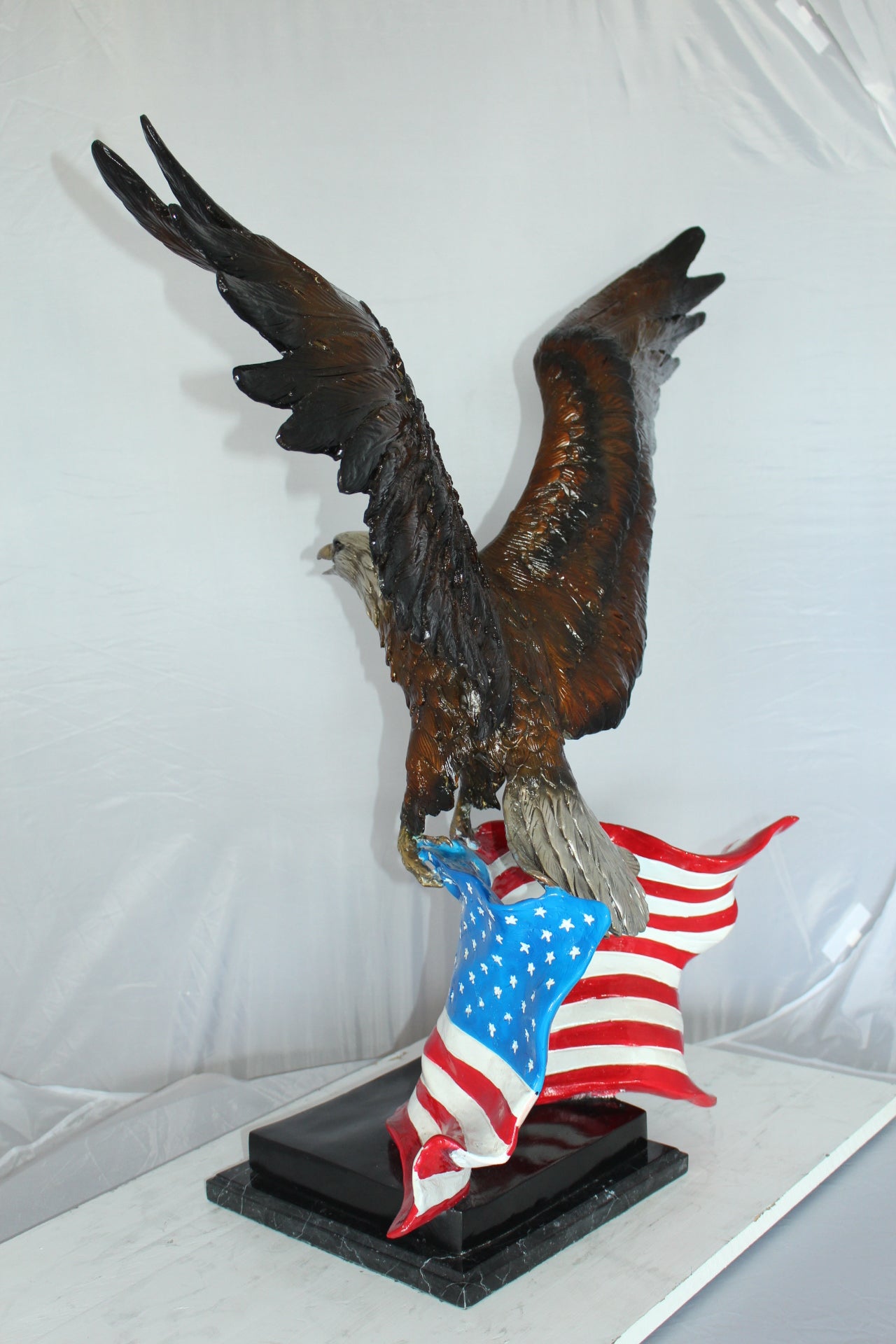 Eagle with American Flag Bronze Statue - Size: 32"L x 14"W x 35"H.