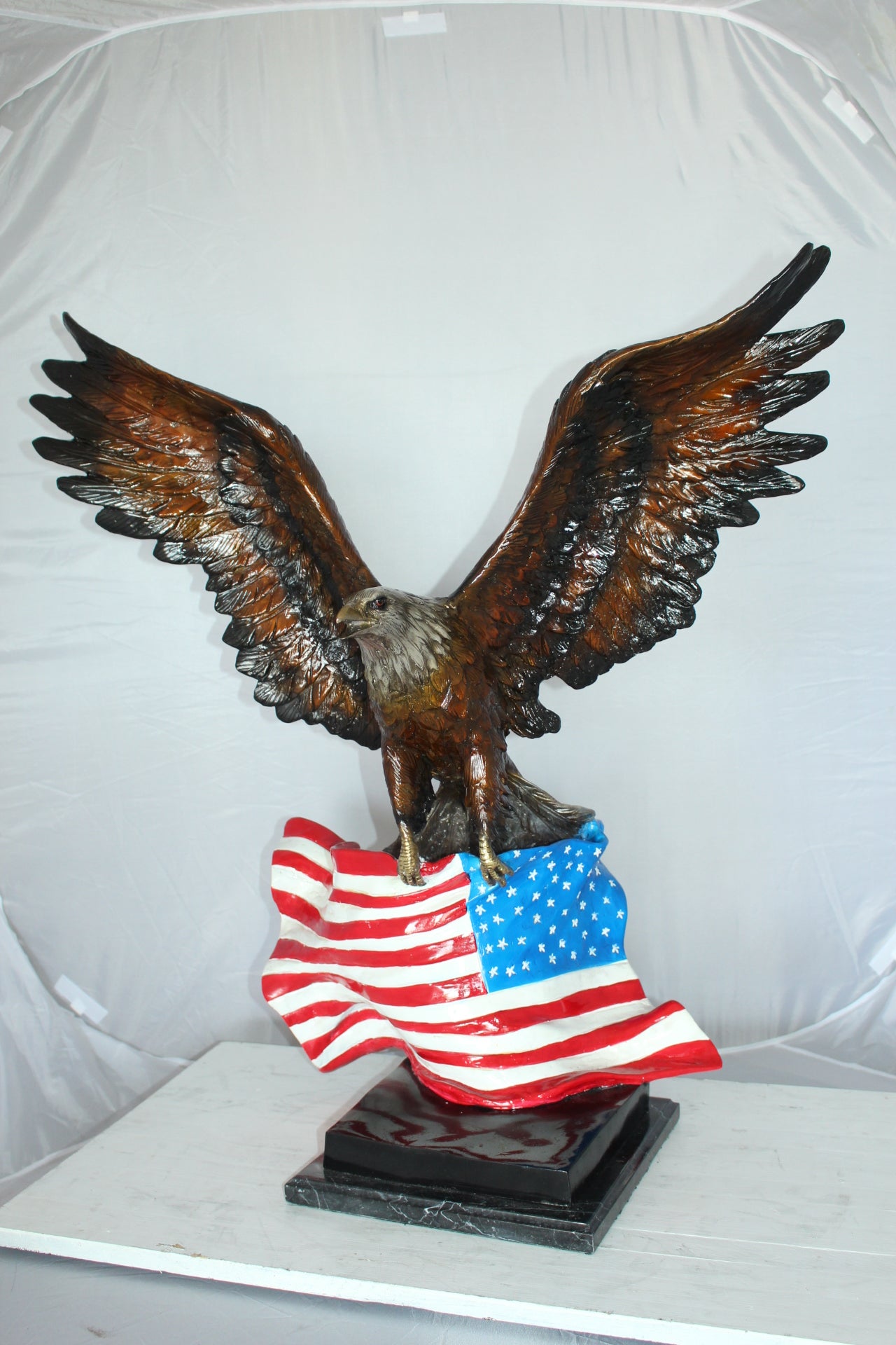 Eagle with American Flag Bronze Statue - Size: 32"L x 14"W x 35"H.